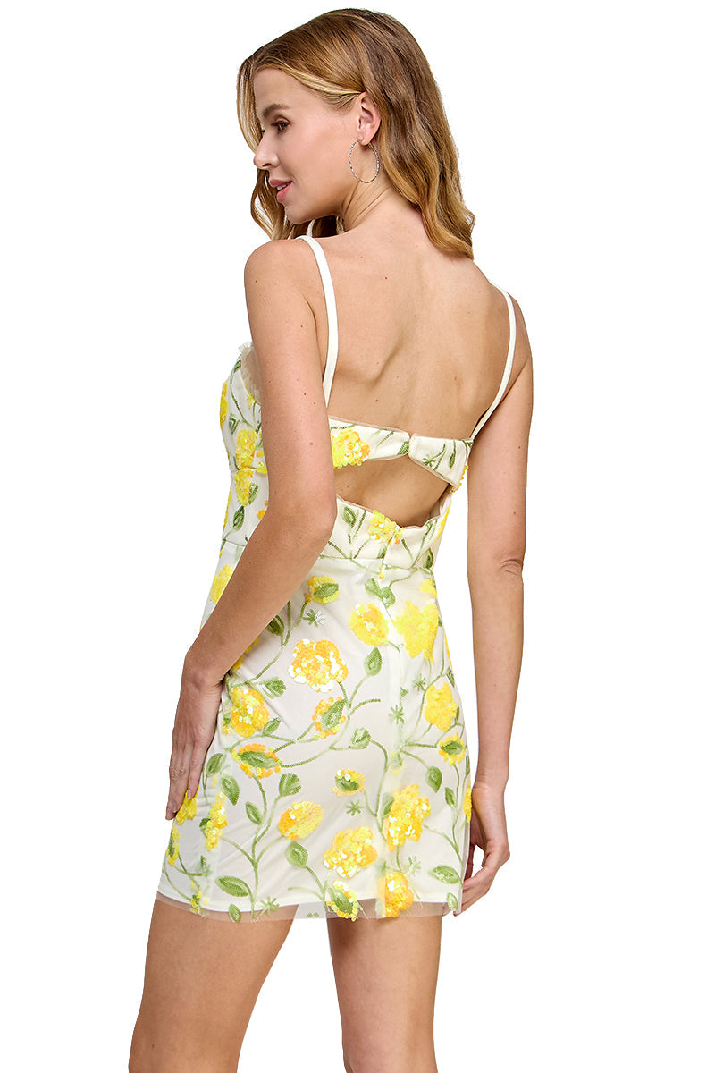Woman in the Short Sequin-Print Party Dress: Morgan 3084, shown from the back, features a sparkling sequin print and chic cut-out details—perfect for a playful, summery party look.