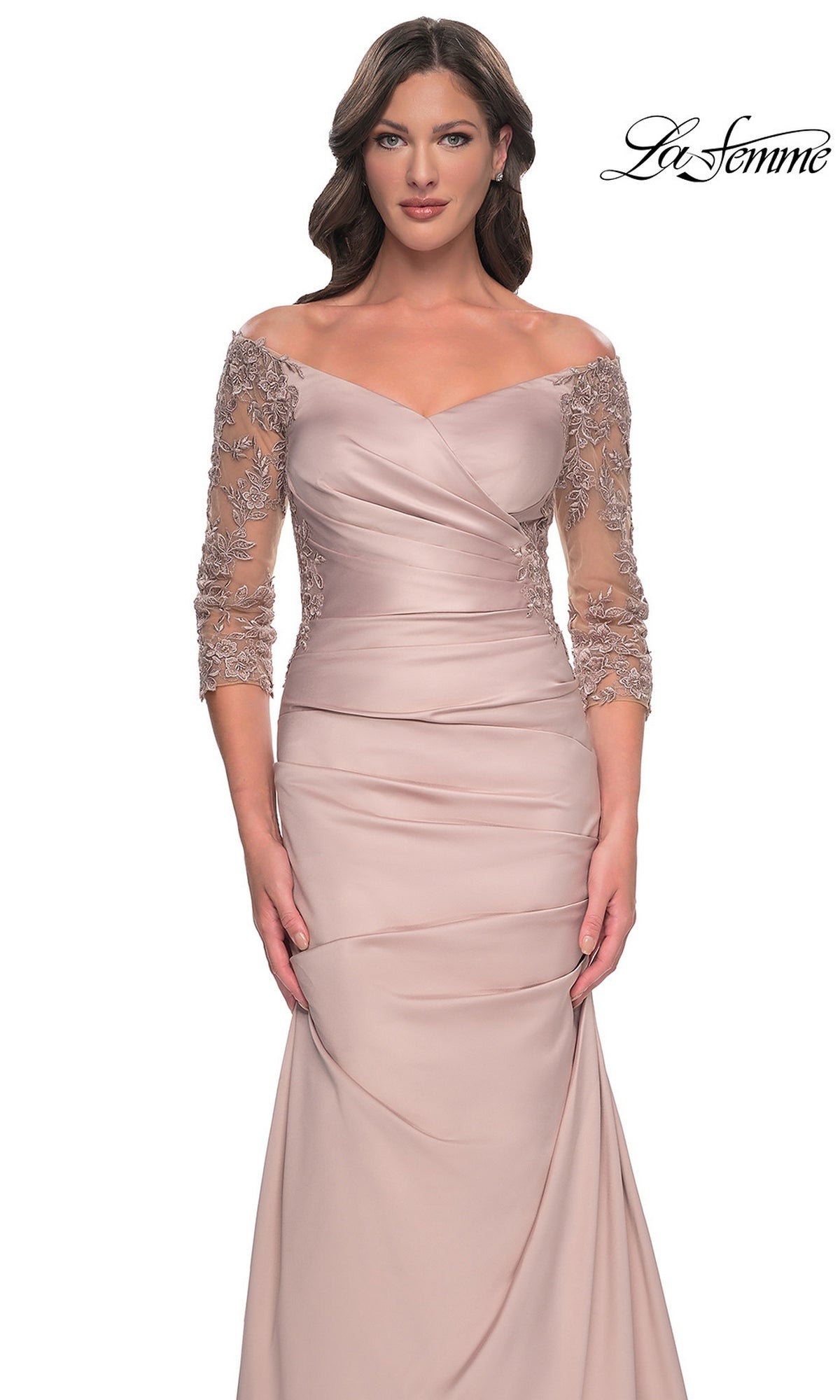 Woman wearing a Long Formal Dress: La Femme 30853, an off-the-shoulder, floor-length mauve gown with a trumpet skirt, ruched bodice, and three-quarter length floral lace sleeves.
