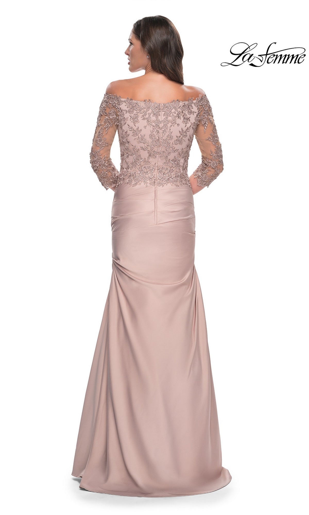 La Femme 30853 is a dusty rose, floor-length off-the-shoulder gown with an embroidered lace bodice, three-quarter length sleeves, and a trumpet skirt.