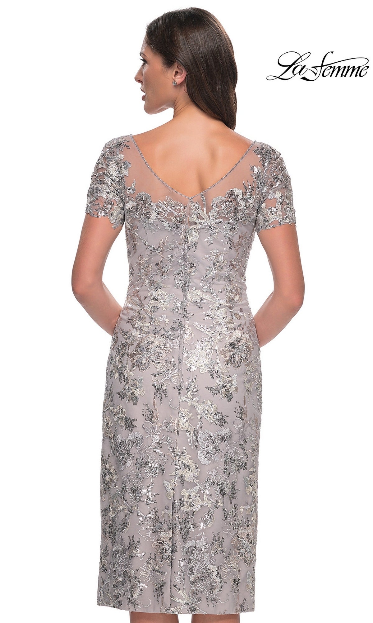 Back view of a Knee Length Wedding Guest Dress: La Femme 30854, a silver dress with short sleeves, silver floral embroidery, sequins, and a sheer illusion neckline.