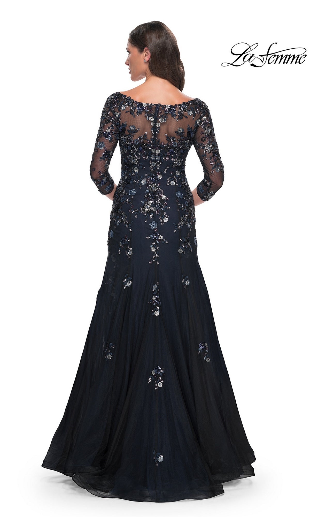 Back view of a woman wearing a Long Formal Dress: La Femme 30860, a floor-length navy blue mermaid gown with a sheer neckline, three-quarter sleeves, and floral sequin embellishments.