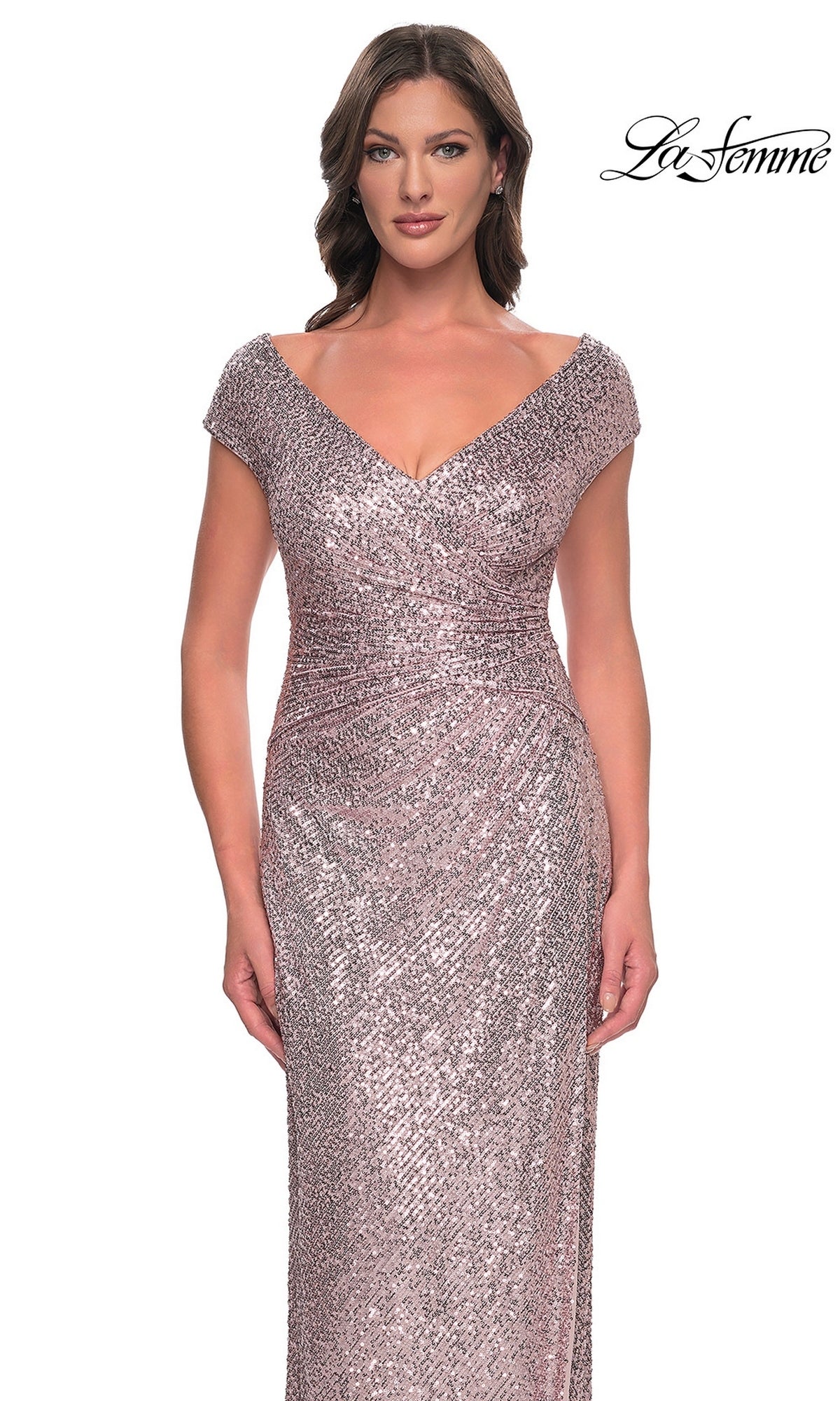 A woman wears a rose-gold, V-neck, cap-sleeve, floor-length sequin sheath dress with a ruched waist, the La Femme 30865.