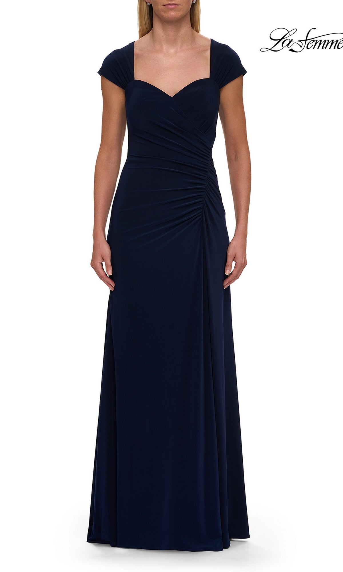 A woman wearing the La Femme 30874 floor-length navy cap-sleeve formal dress, featuring a ruched bodice and sweetheart neckline.