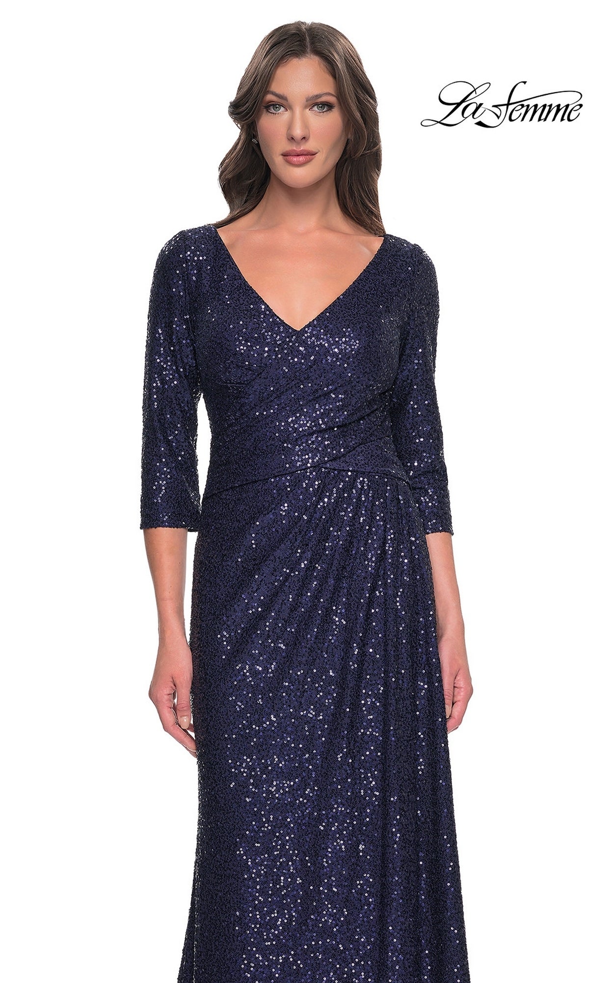 A woman wearing the Long Formal Dress: La Femme 30879, a navy sequin V-neck gown with three-quarter sleeves, a side-ruched waist, and a floor-length silhouette.