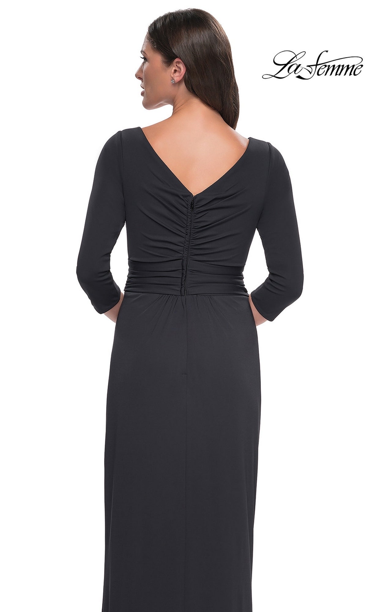 Back view of a woman wearing the Long Formal Dress: La Femme 31014, a black, long-sleeved, floor-length faux wrap evening gown with a ruched bodice and V-neckline.