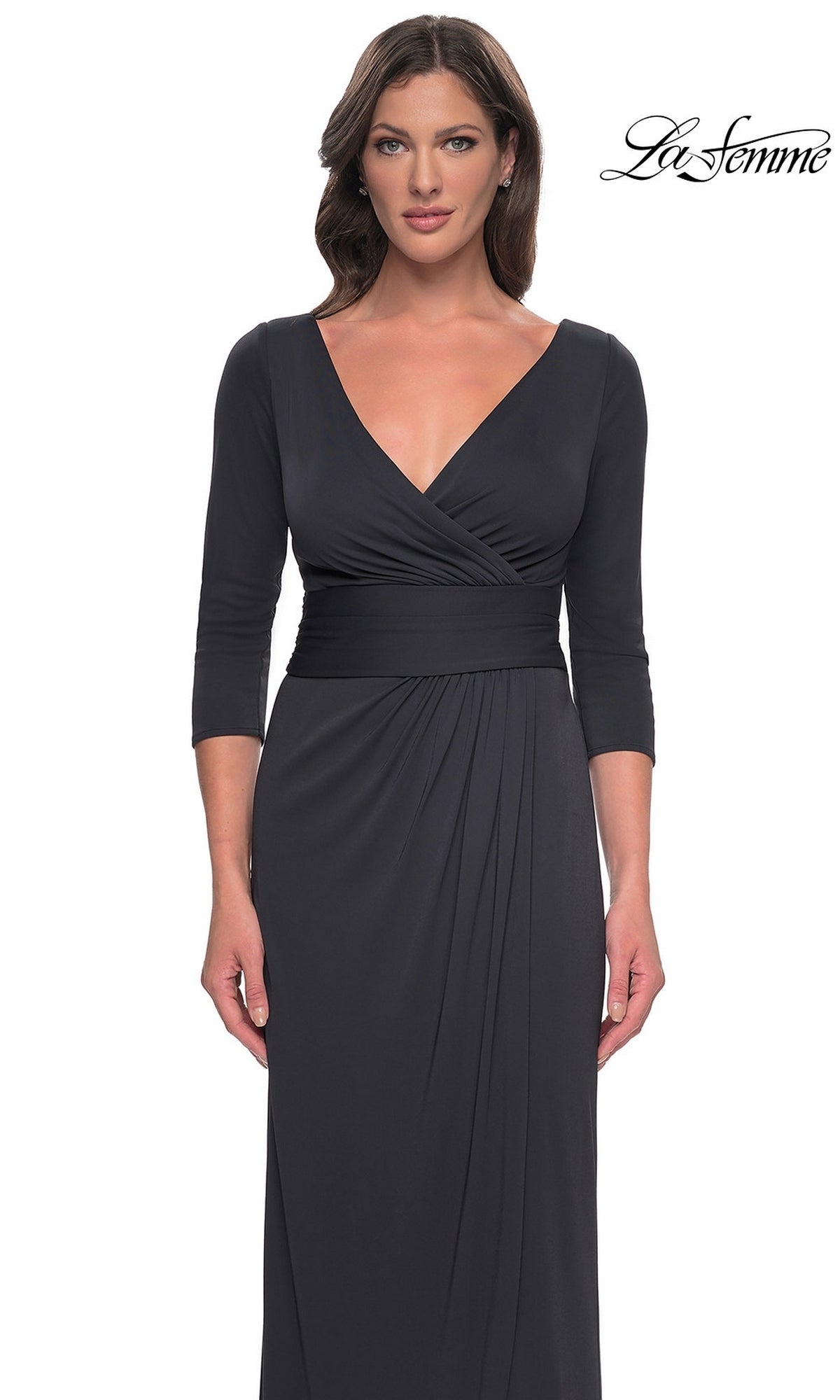 A woman wearing a black, long-sleeved, floor-length faux wrap Long Formal Dress: La Femme 31014 with a V-neckline.