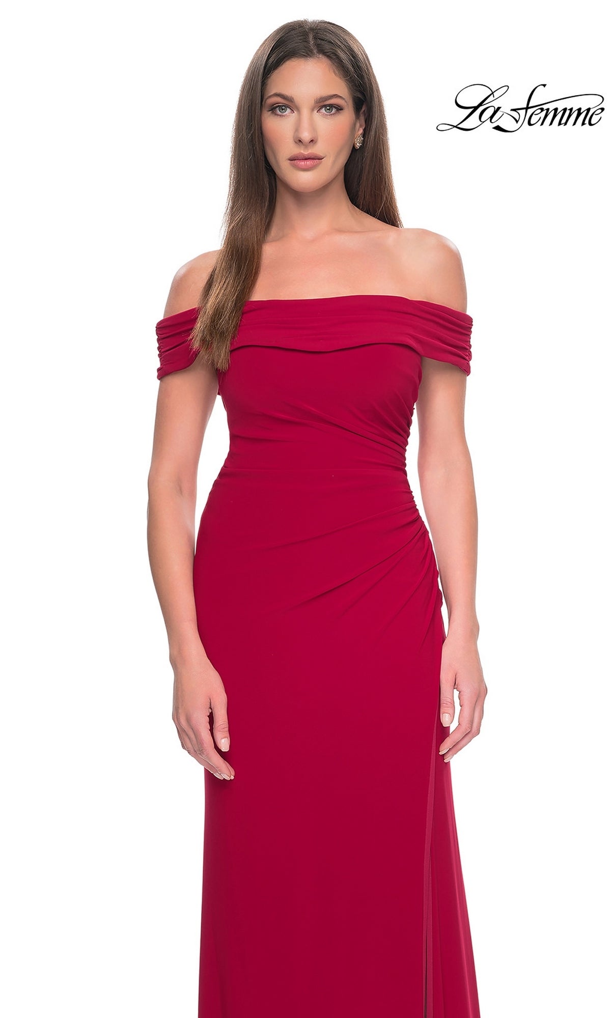 A woman wears a red, off-the-shoulder Long Formal Dress: La Femme 31086 featuring side ruching and a high-leg slit.
