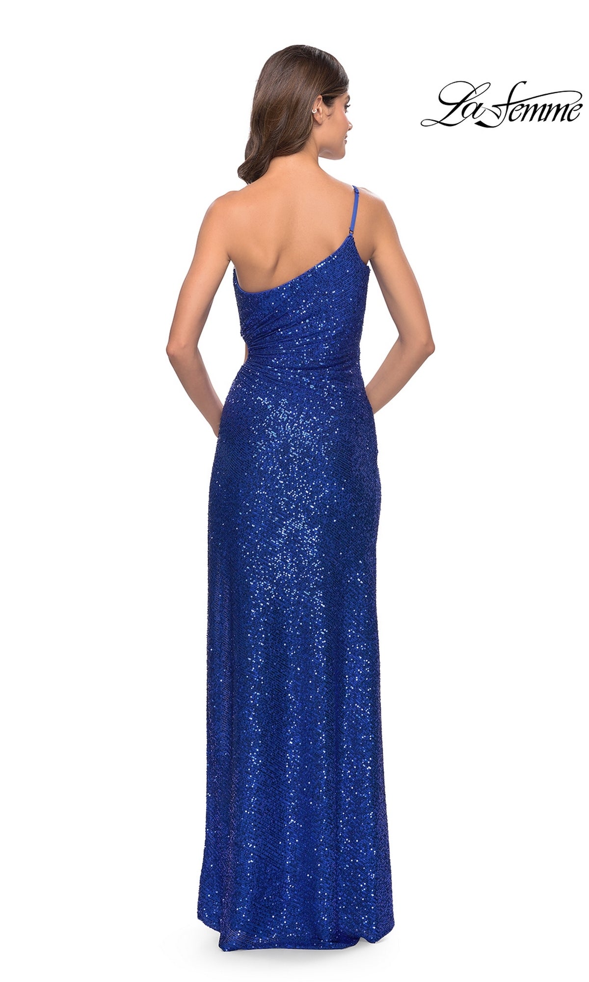 A woman wearing the La Femme One-Shoulder Long Sequin Prom Dress 31089 in blue stands with her back to the camera against a white background.