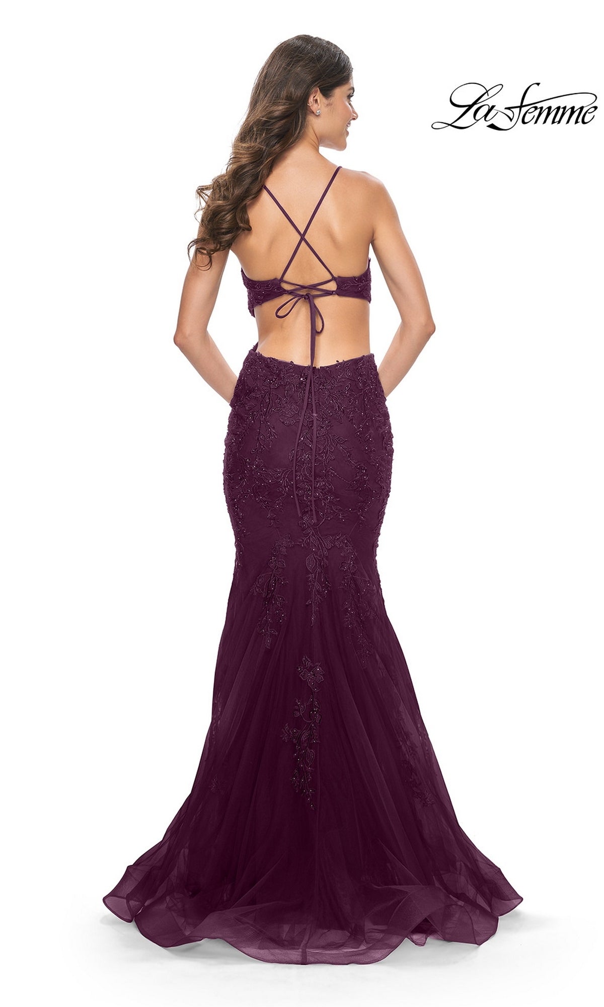 Back view of a deep purple La Femme 31132 mermaid gown featuring a tulle skirt, a lace-up bodice, and floral embroidery with beaded lace appliques.