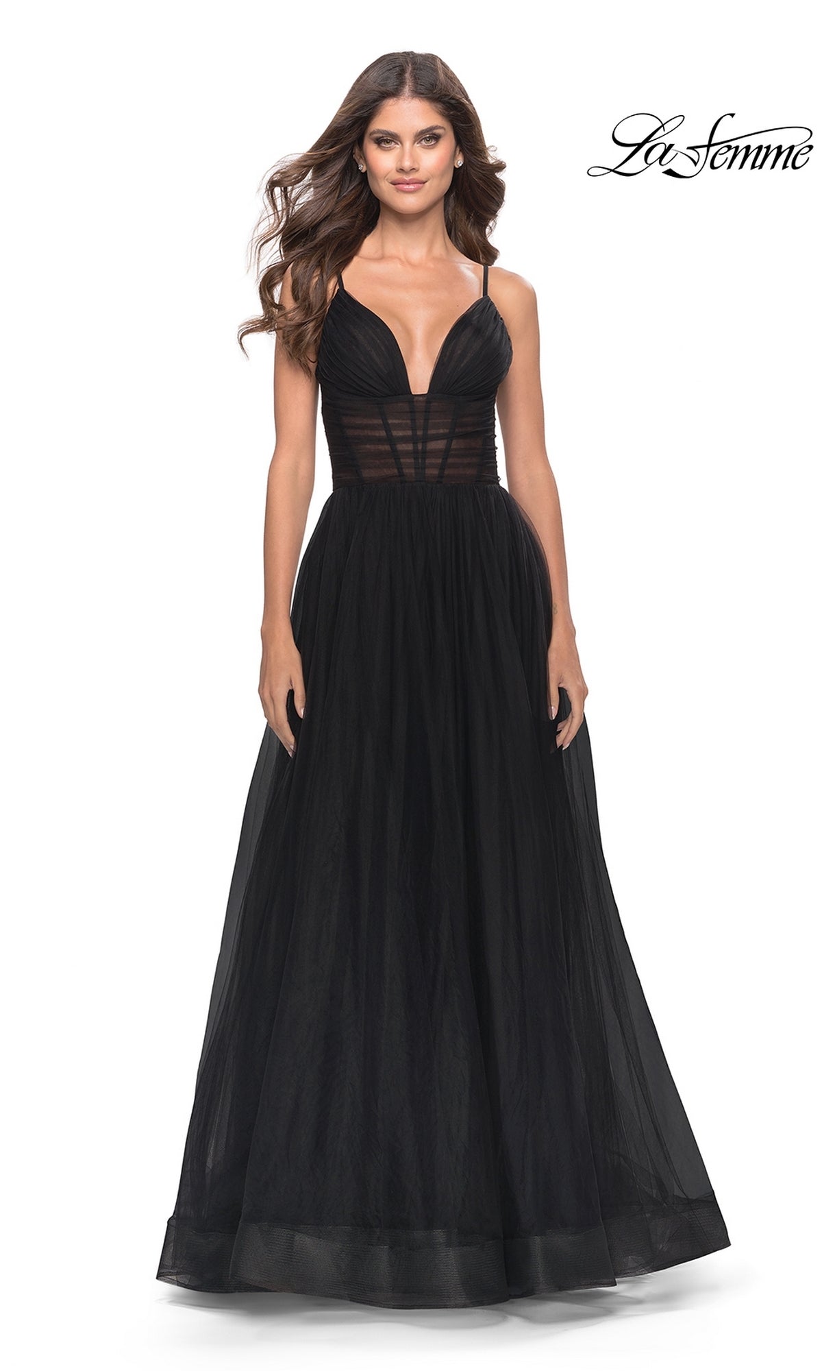 Woman in a sleeveless black Sheer-Waist La Femme Long Prom Ball Gown 31147 with deep V neckline and tulle skirt, standing against a plain white background.