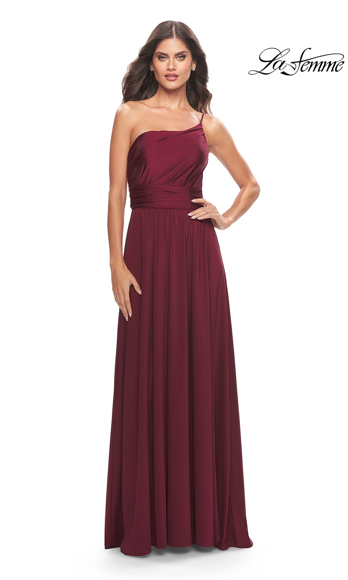 A woman models the One-Shoulder Long La Femme Formal Dress 31170, featuring a fitted waist and floor-length design, standing against a plain white background.
