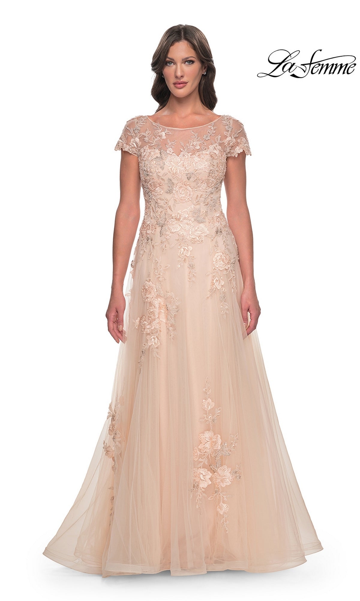 La Femme 31198 is a champagne-colored floor-length gown featuring a sheer neckline, cap sleeves, and beaded lace appliques on an A-line tulle skirt.
