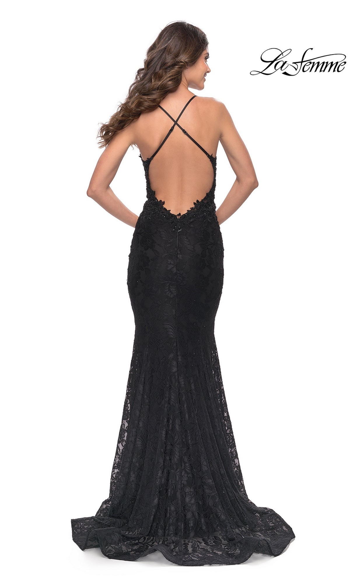 A woman stands elegantly with her back to the camera, wearing the La Femme Beaded-Lace Long Prom Dress 31265 in black, featuring a floor-length design, beaded lace, a low-cut open back, and crisscross straps.