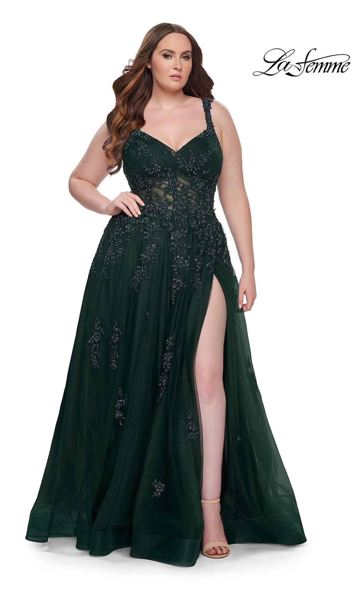 A woman wearing the La Femme Long Prom Dress 31383, a dark green sleeveless formal gown with floral embellishments and a thigh-high slit, stands against a white background. The La Femme logo appears in the top right corner.