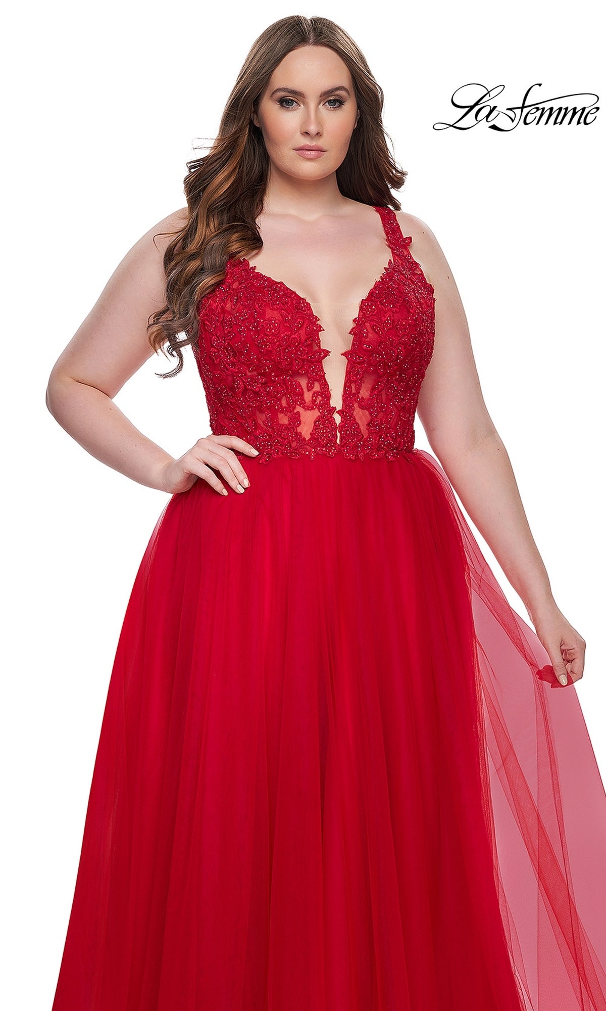 A woman wears the La Femme Long Prom Dress 31394—sleeveless with an embroidered lace bodice and a full tulle skirt—posing against a white background.