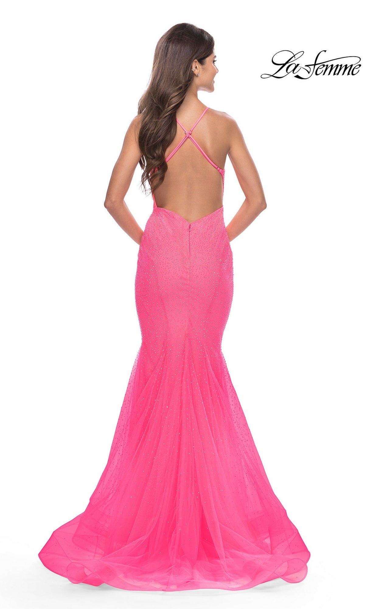 Back view of the Long Prom Dress: La Femme 31407, a hot pink, floor-length mermaid gown featuring a low back, spaghetti straps, and a crystal-embellished tulle skirt.