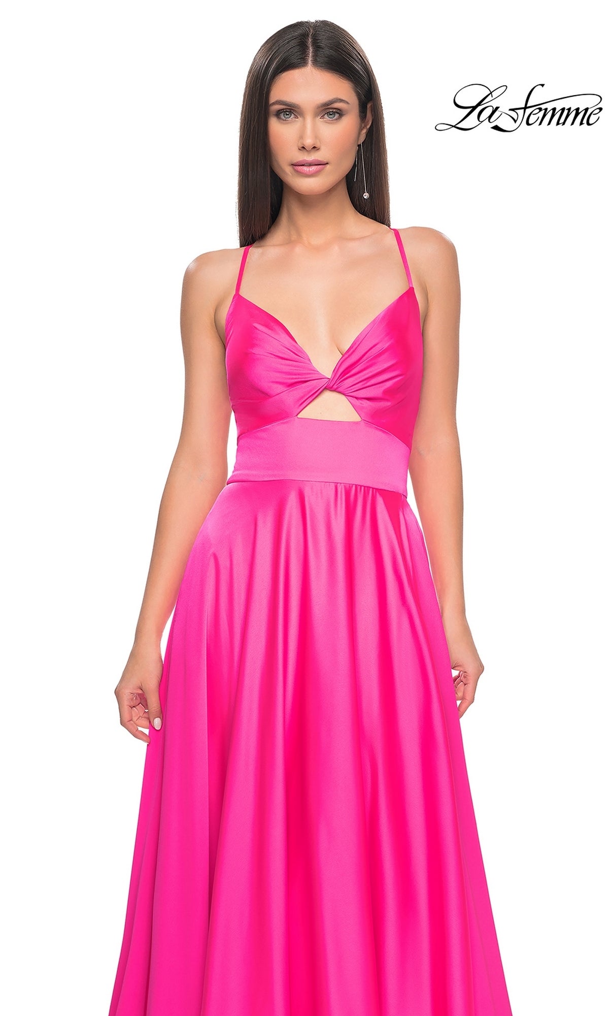 A woman models the La Femme Twist-Front Long A-Line Prom Dress 31412 in bright pink satin with a sleeveless cut and bust cutout, standing against a white background. The La Femme logo appears in the top right corner.