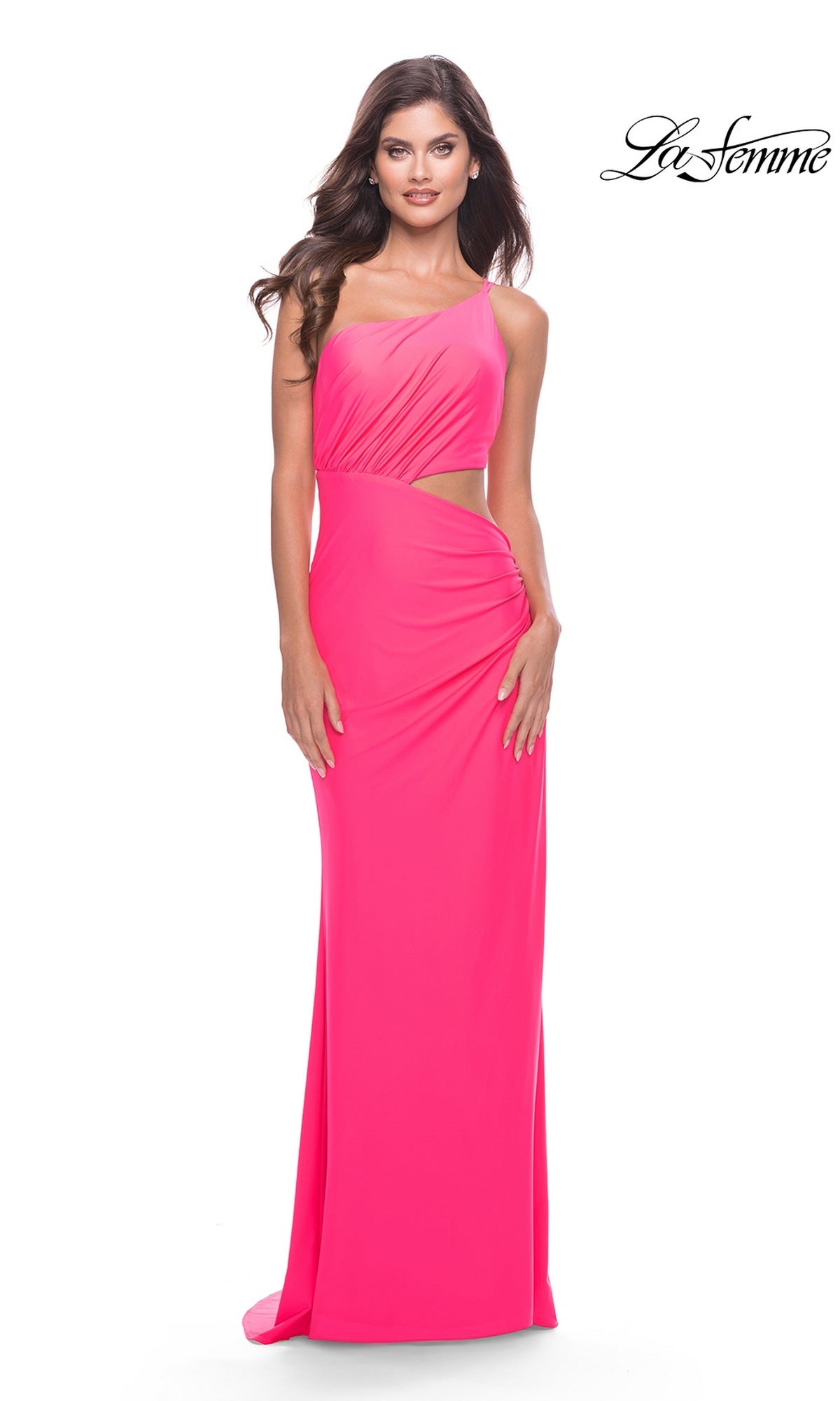 A woman models the La Femme Long Prom Dress 31443, a bright pink fitted gown with a side cutout, standing against a white background. The