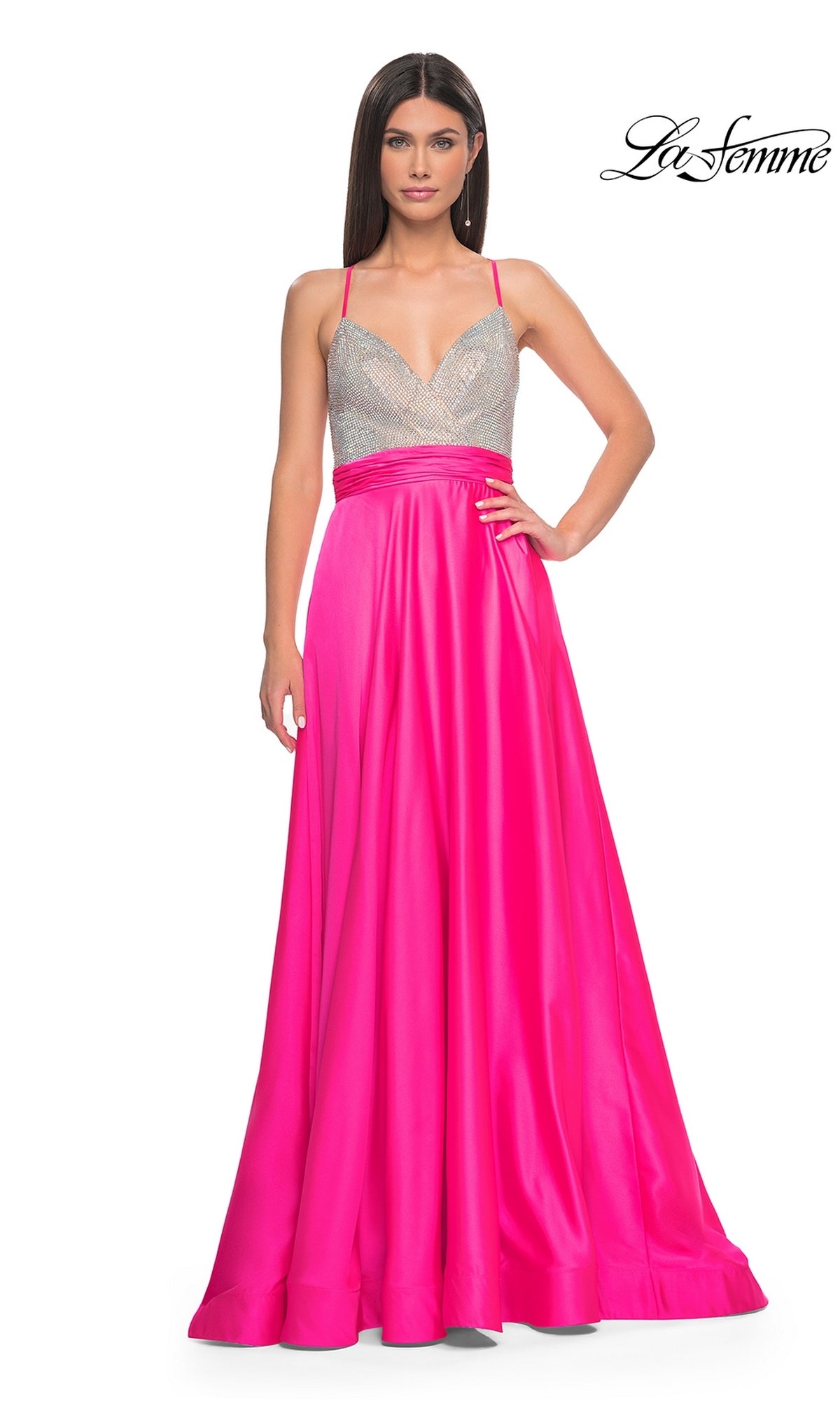 A woman wears the La Femme Neon Pink Long Prom Dress 31448, featuring a sleeveless beaded bodice and a neon pink skirt. The La Femme logo is in the top right corner.