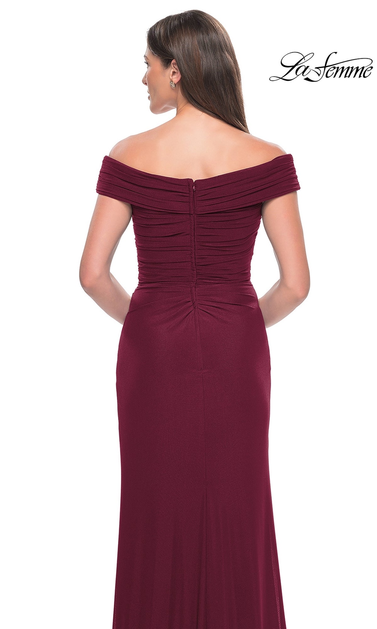 A woman seen from the back wears the La Femme Off-the-Shoulder Long Prom Dress 31677 in burgundy, featuring ruched detailing and a fitted silhouette—an elegant choice for formal events and special occasions.