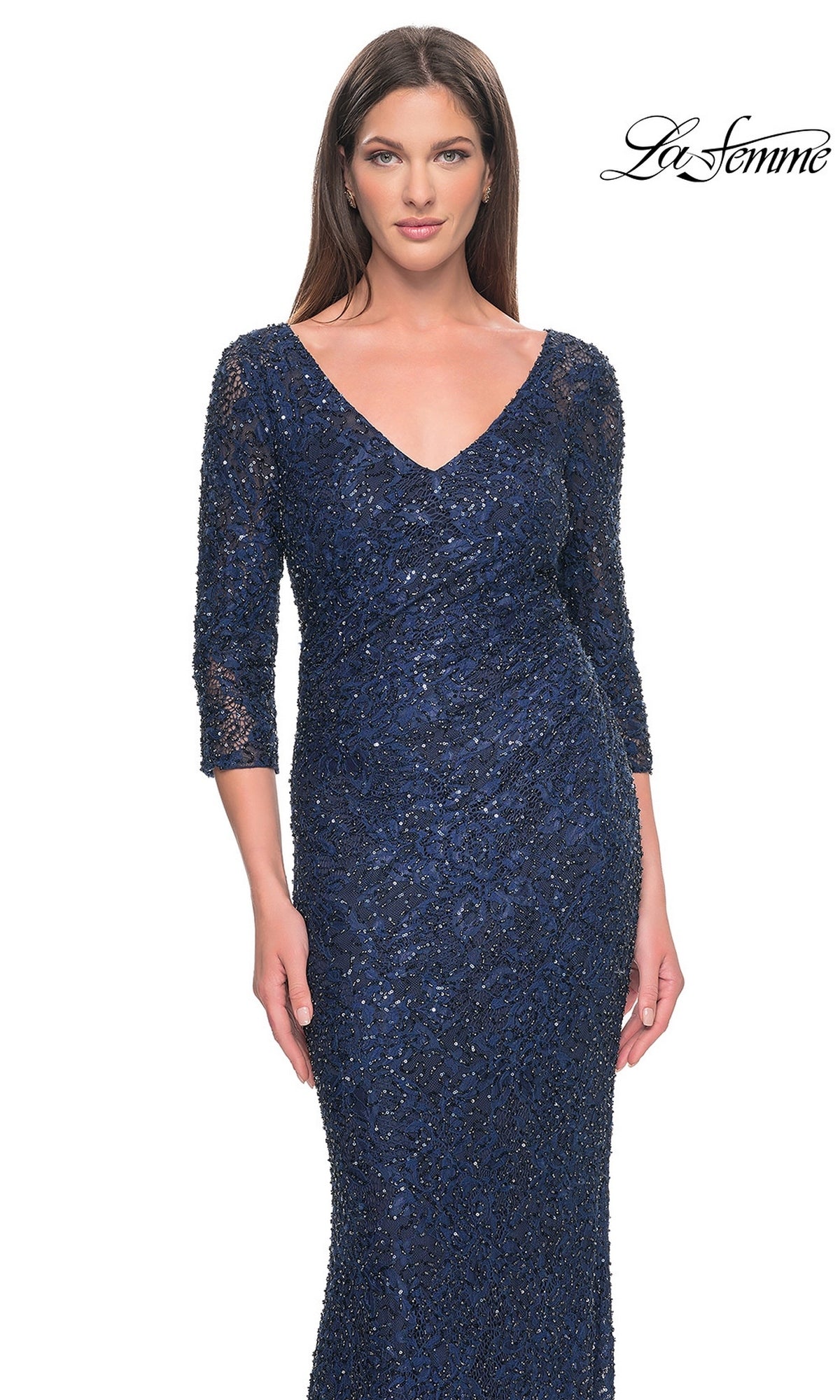 A woman wears a navy blue, three-quarter sleeve, v-neck Long Formal Dress: La Femme 31721 covered in lace and beadwork.