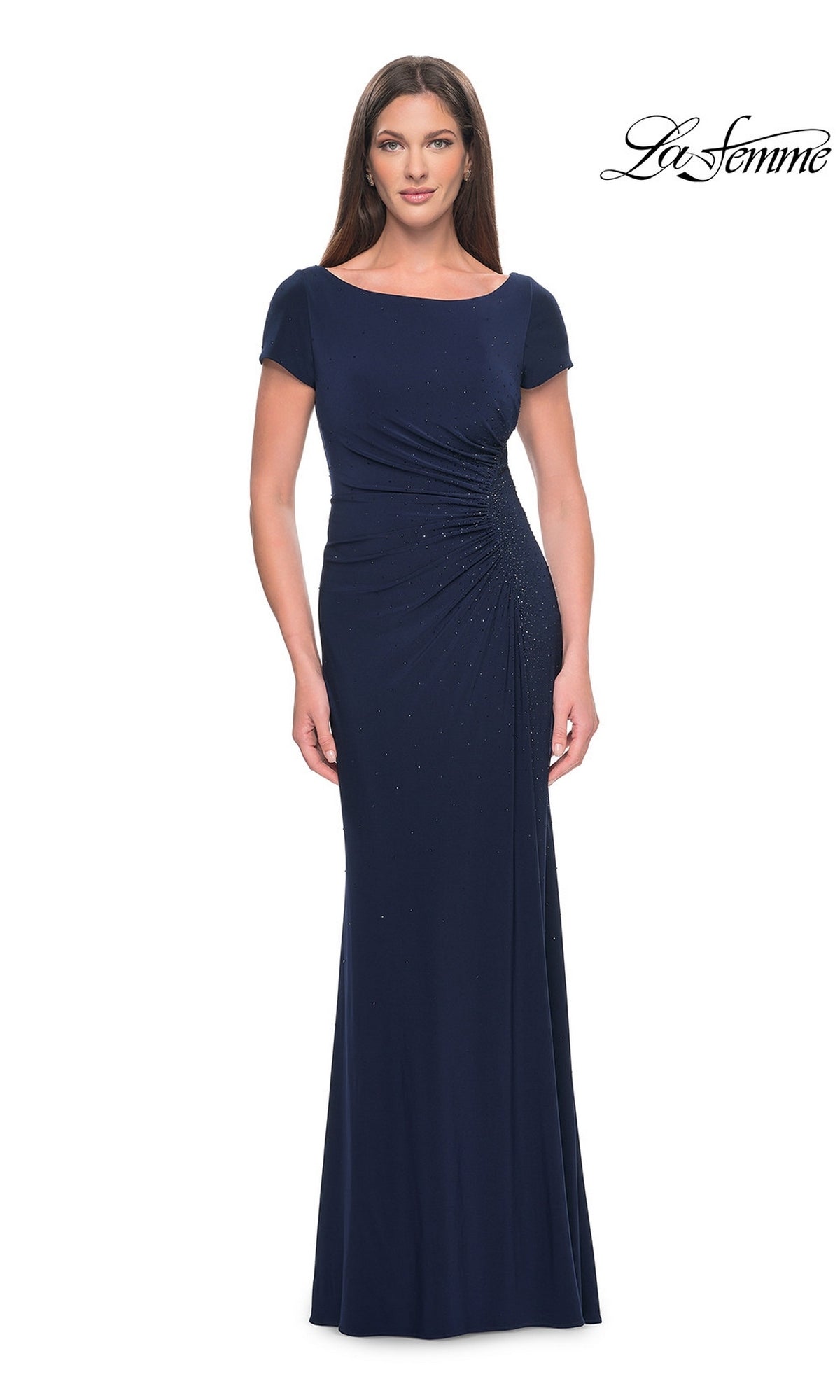 A woman wearing a floor-length navy blue La Femme 31773 formal dress with short sleeves and side ruching.