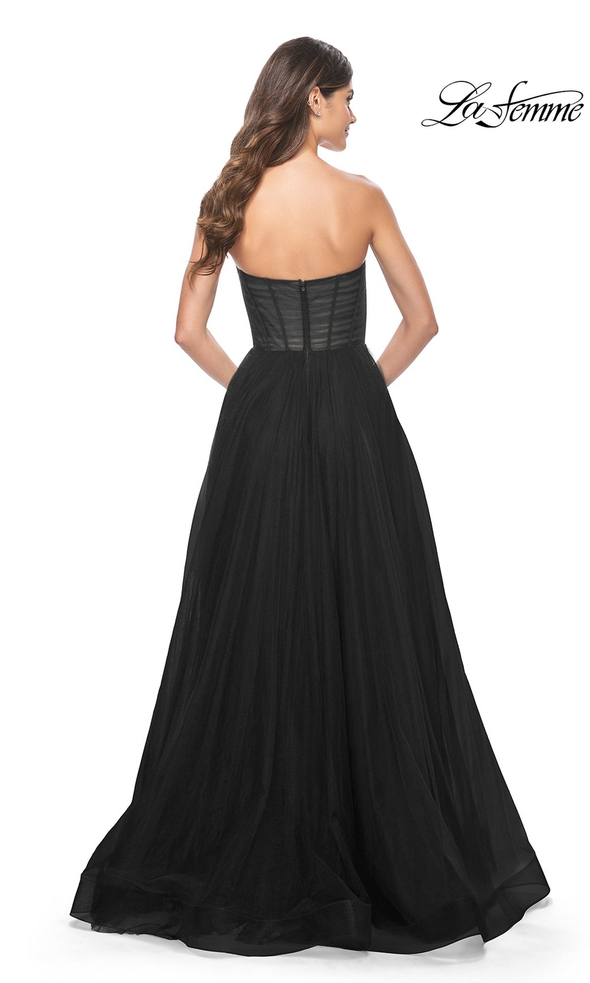 Woman seen from the back wearing the La Femme Strapless Long A-Line Prom Dress 31971, featuring a fitted bodice and flowing skirt. The La Femme logo appears in the upper right corner.