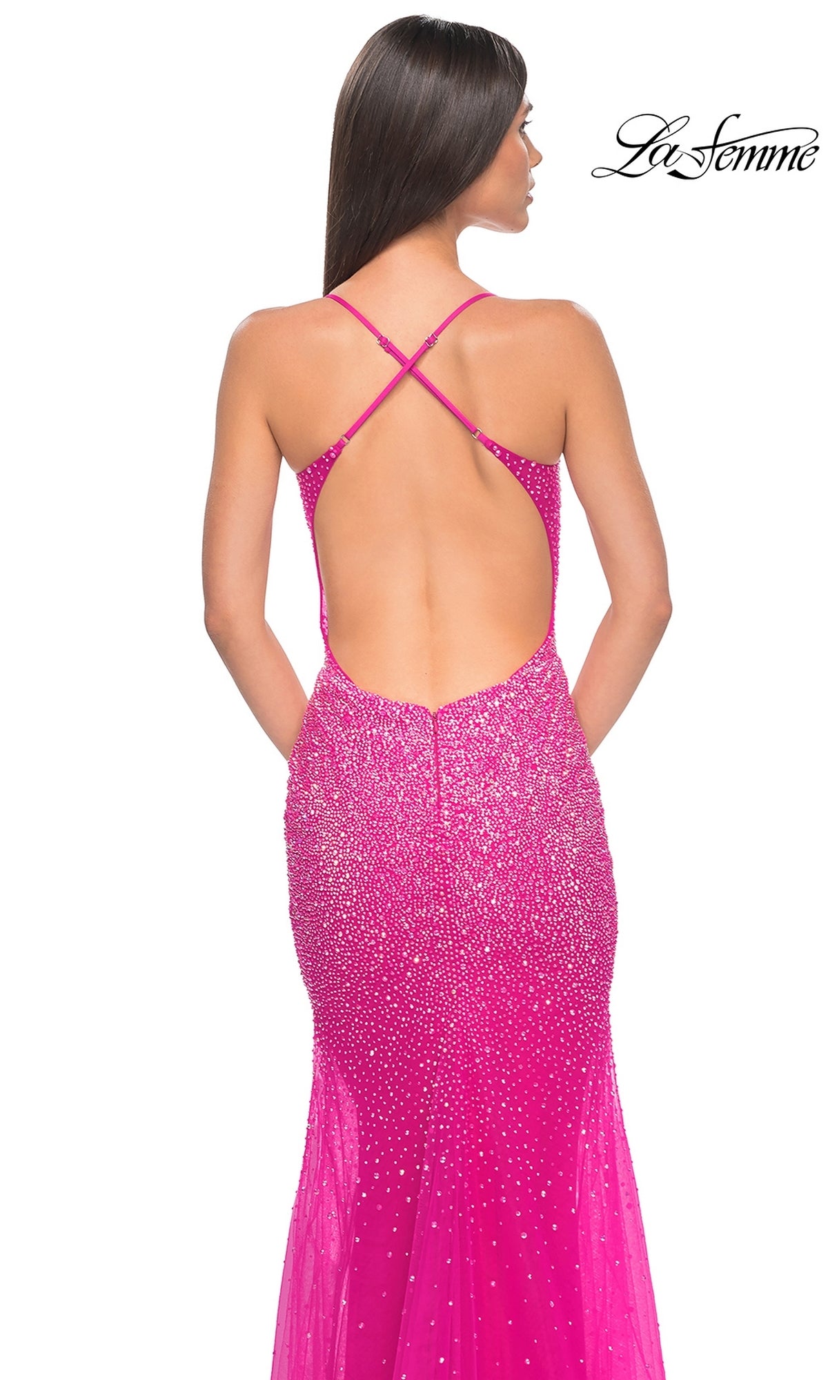 Woman seen from behind in the La Femme Sheer-Waist Long Beaded Prom Dress 32007, featuring bright pink sequins, a floor-length silhouette, low open back, and crisscross straps.