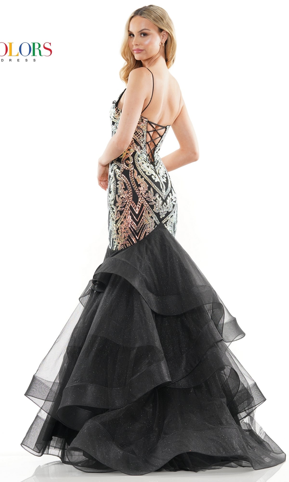A woman poses with one arm on her waist wearing the Sequin-Print Long Mermaid Prom Dress 3200, featuring a corset-style sequined bodice, lace-up back, and layered black tulle mermaid skirt.
