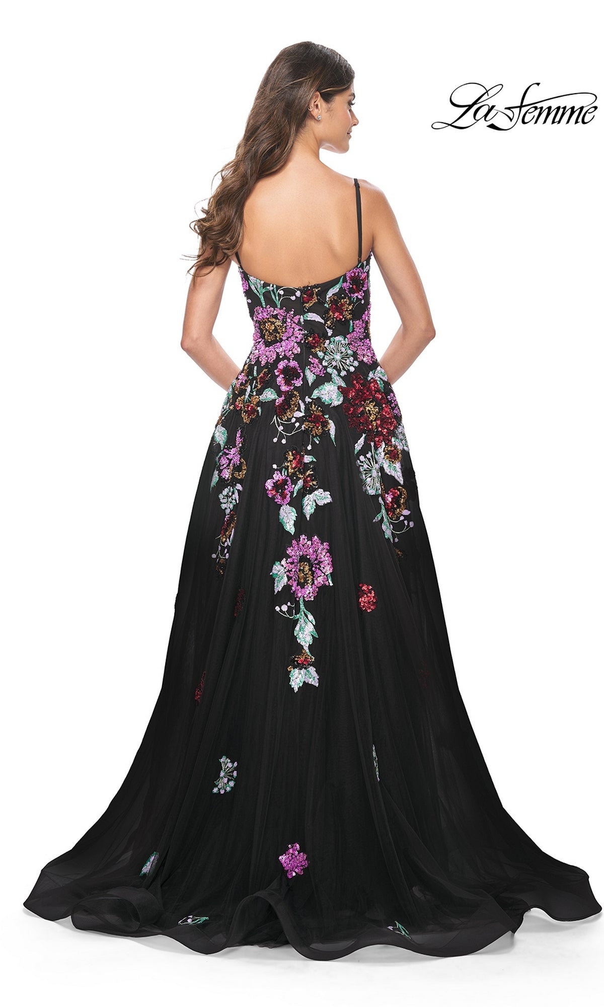 Woman in loose waves photographed from the back, wearing La Femme Sequin-Floral Long Prom Dress 32019—a black a-line gown with colorful sequin floral embroidery and thin shoulder straps.