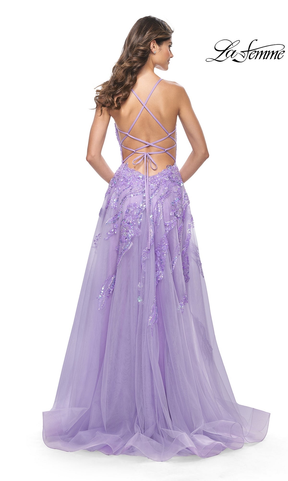 A woman in the La Femme Sequin-Lace Long A-Line Prom Dress 32032, featuring lavender sequins and a floor-length silhouette with a lace-up open back.