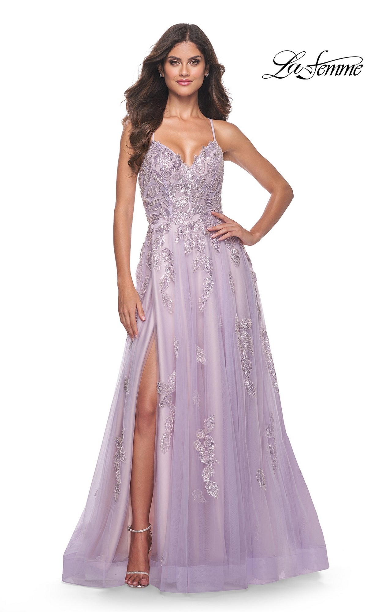 A woman stands against a white background wearing the La Femme Sequin-Embroidered Long Prom Dress 32090 in lavender, featuring a floor-length silhouette, sleeveless design, sweetheart neckline, sequin embroidery, and thigh-high slit.