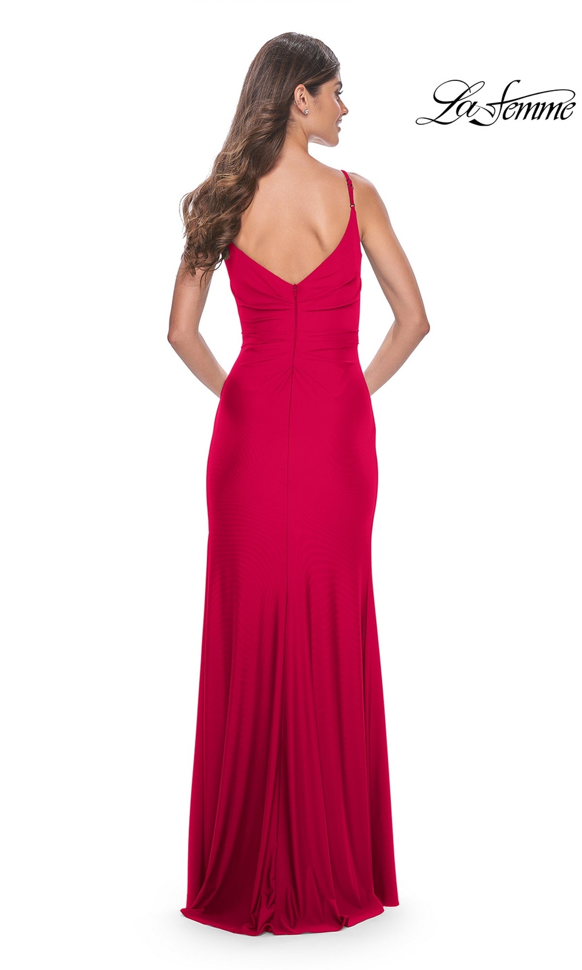 A woman with long brown hair is shown from behind wearing the La Femme Faux-Wrap Long Jersey Prom Dress 32115, a sleeveless, floor-length gown with a V-shaped back. The white background displays the