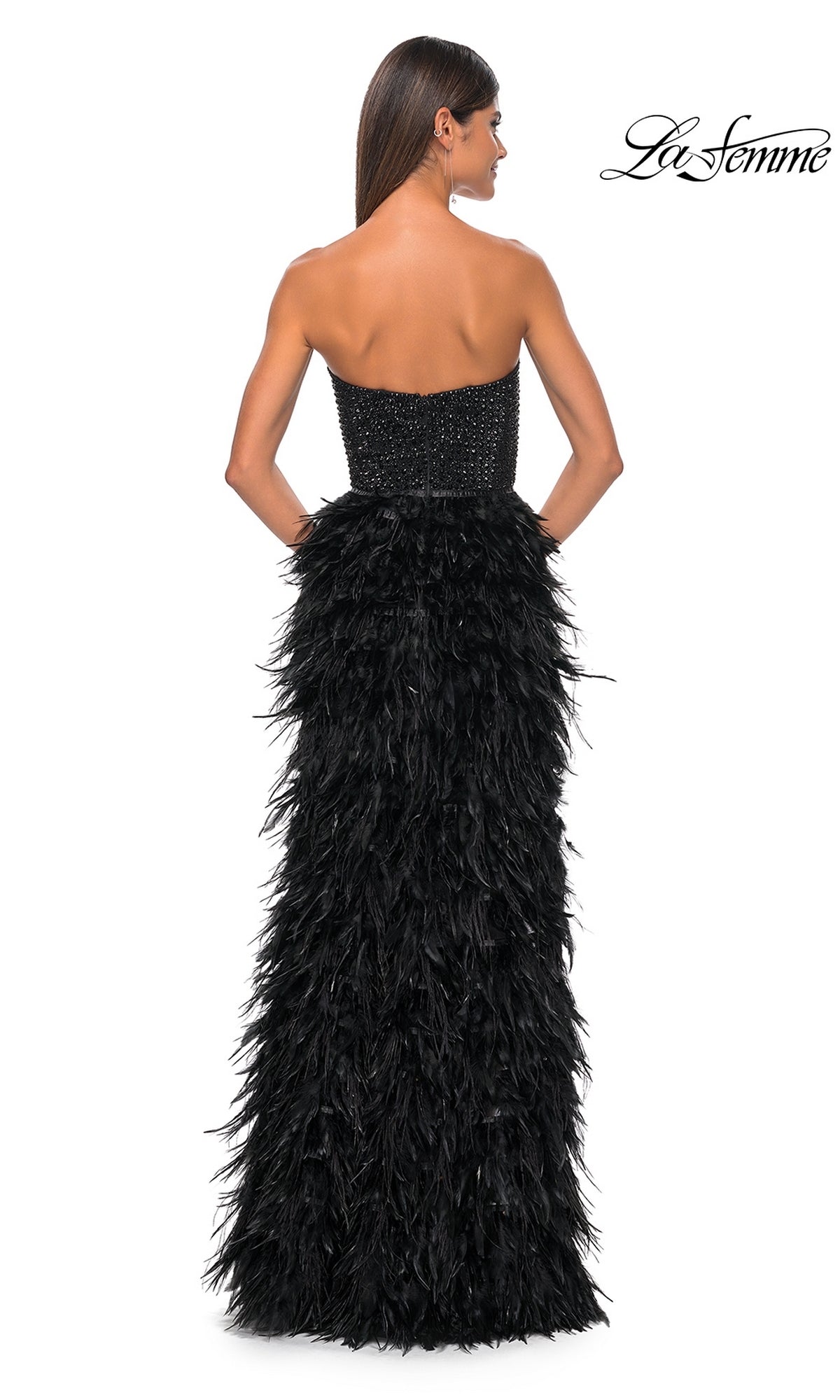 A woman is shown from the back wearing the La Femme Feather Strapless Long Prom Dress 32165, featuring an embellished sweetheart bodice and a dramatic feathered skirt. The La Femme logo appears in the top right corner.