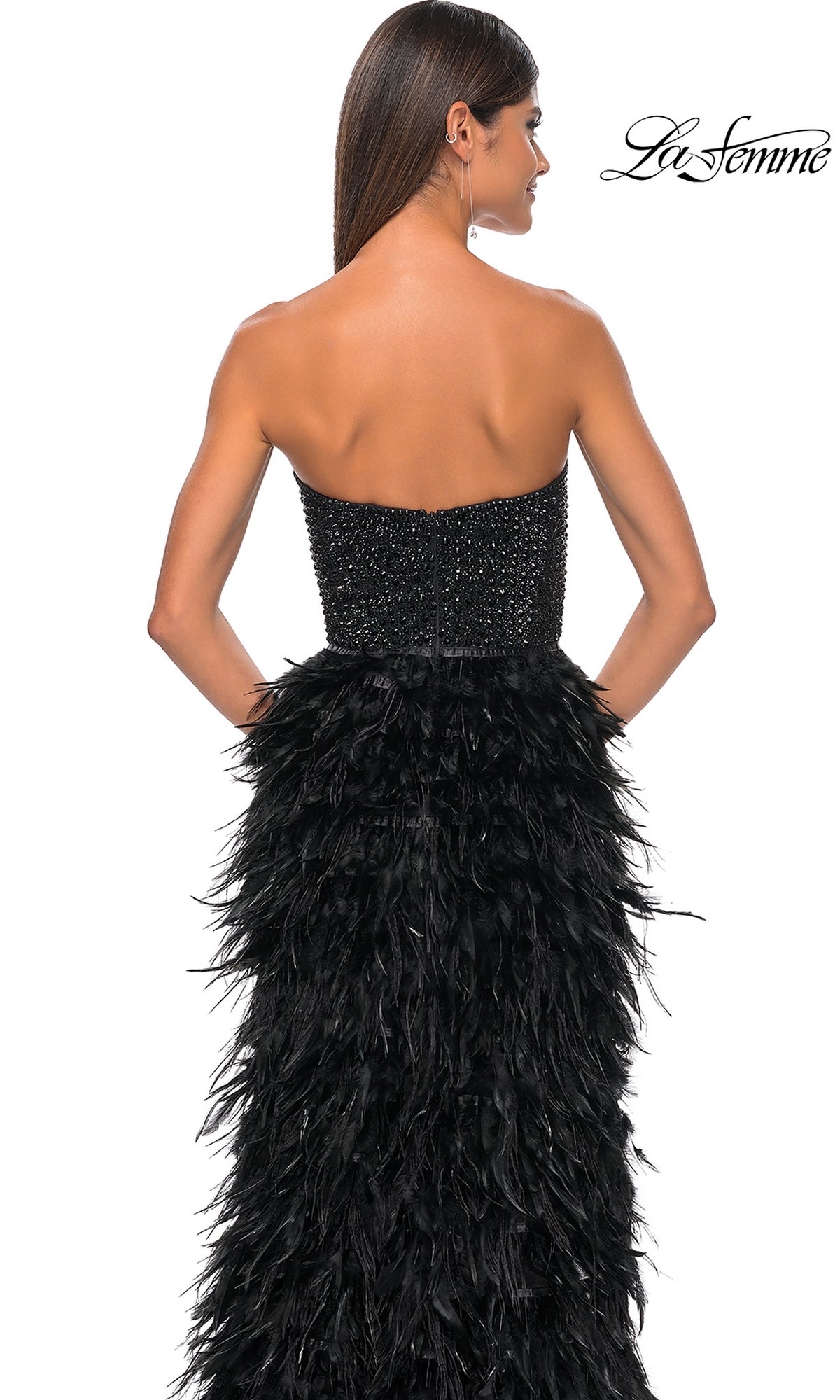 Woman wearing the La Femme Feather Strapless Long Prom Dress 32165, featuring an embellished sweetheart bodice and feathered skirt, shown from the back against a plain white background.