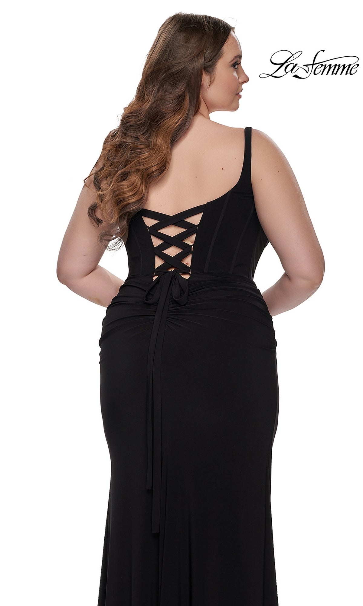 A woman wearing the La Femme Plus-Size Long Lace-Up Prom Dress 32190 stands with her back to the camera, showing off the lace-up detail. The La Femme logo is visible in the top right corner.