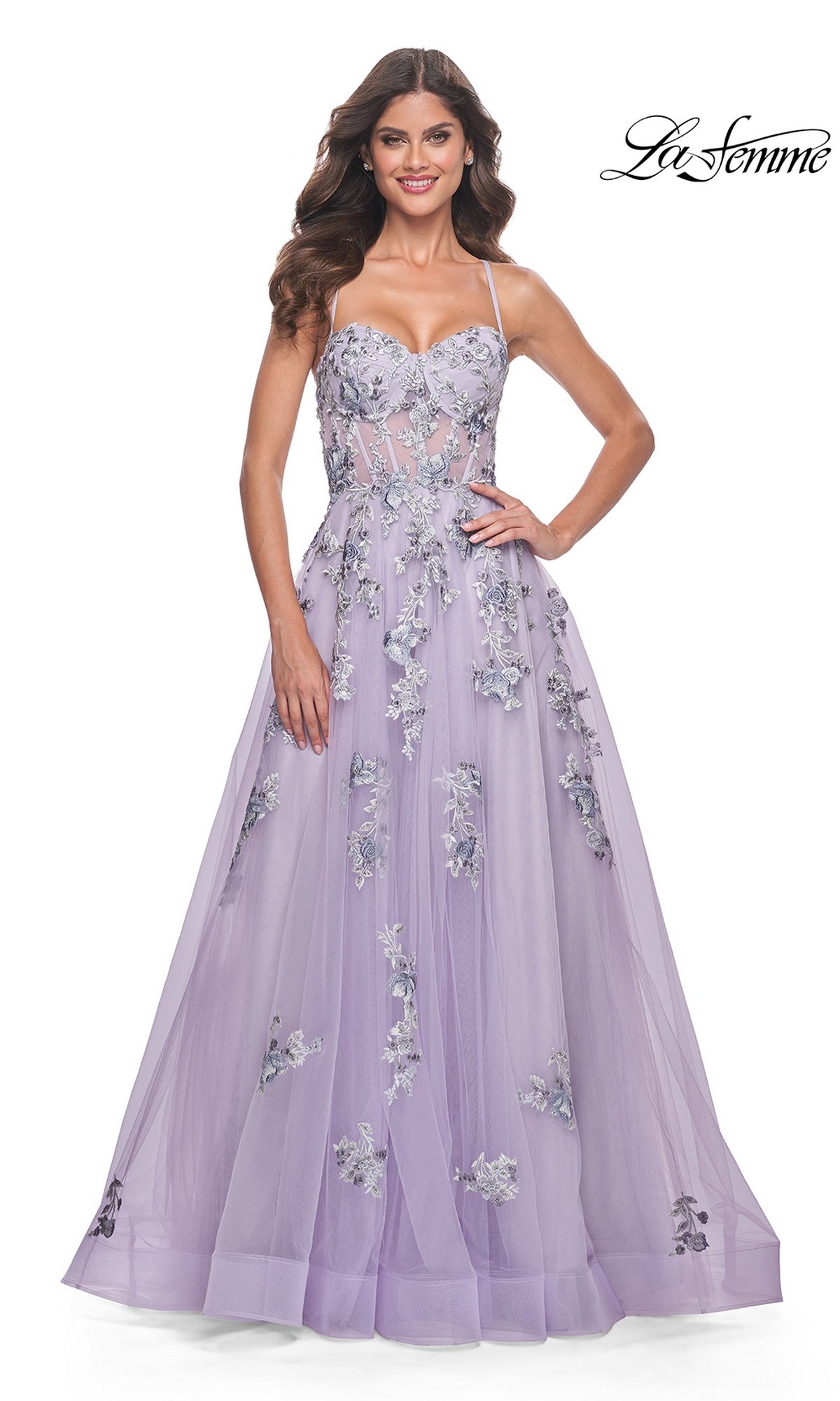A woman models the La Femme Long Lavender A-Line Prom Dress 32221, featuring floral embroidery, thin straps, and a fitted bodice, against a white background with the La Femme logo in the top right corner.
