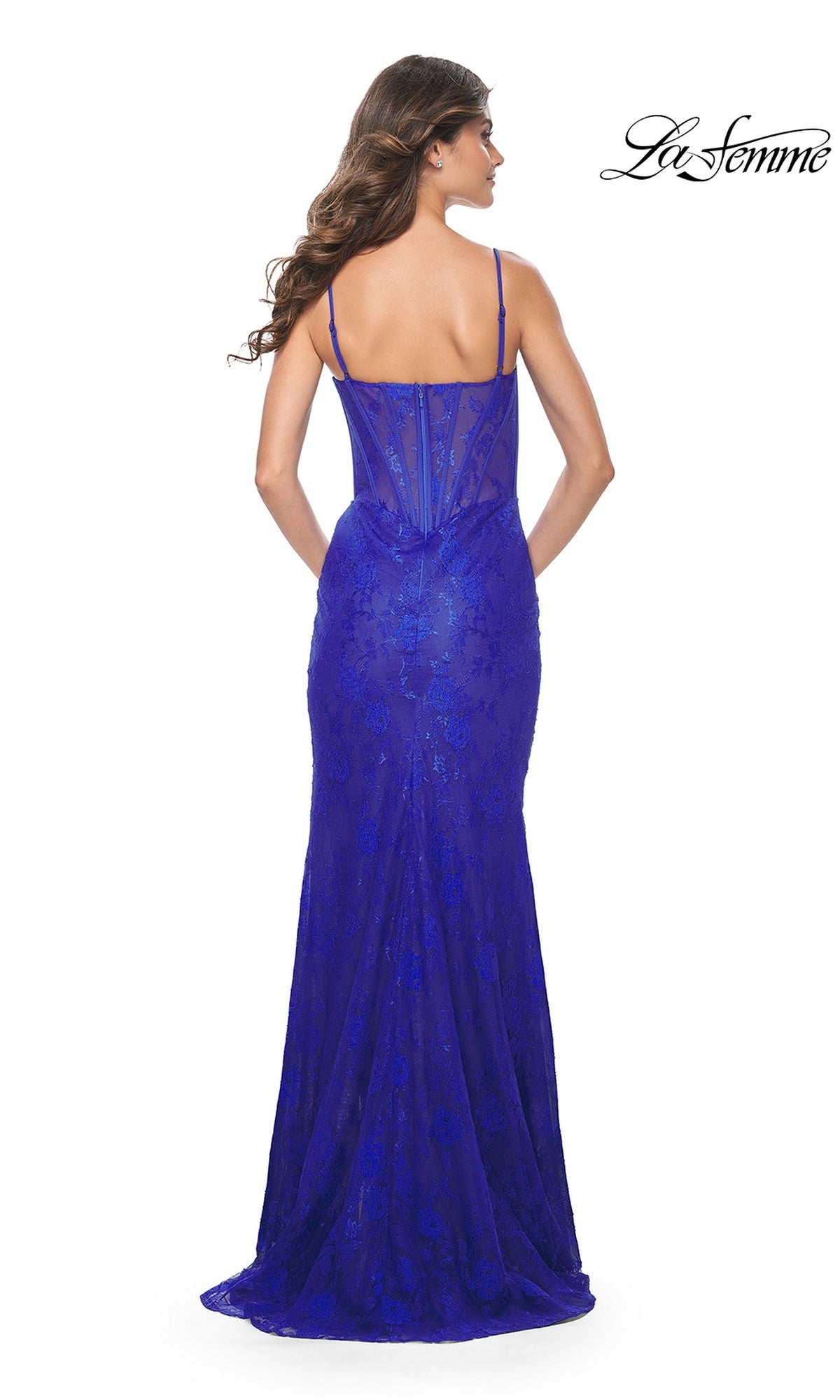 A woman faces away, modeling the La Femme Corset-Bodice Long Lace Prom Dress 32231—a floor-length, royal blue gown with thin straps and sheer floral lace. The La Femme logo appears in the top right corner.