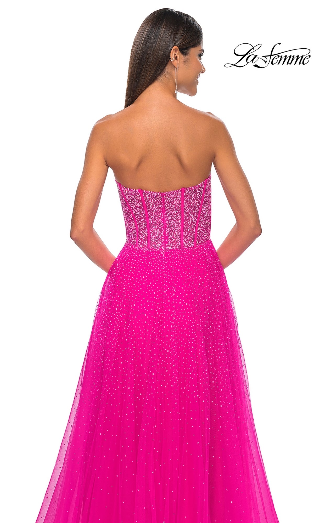 A woman is shown from the back wearing the La Femme Strapless Beaded Long Prom Dress 32278 in bright pink, featuring a beaded corset-style bodice and flowing skirt. The La Femme logo appears in the corner, showcasing this elegant ball gown.
