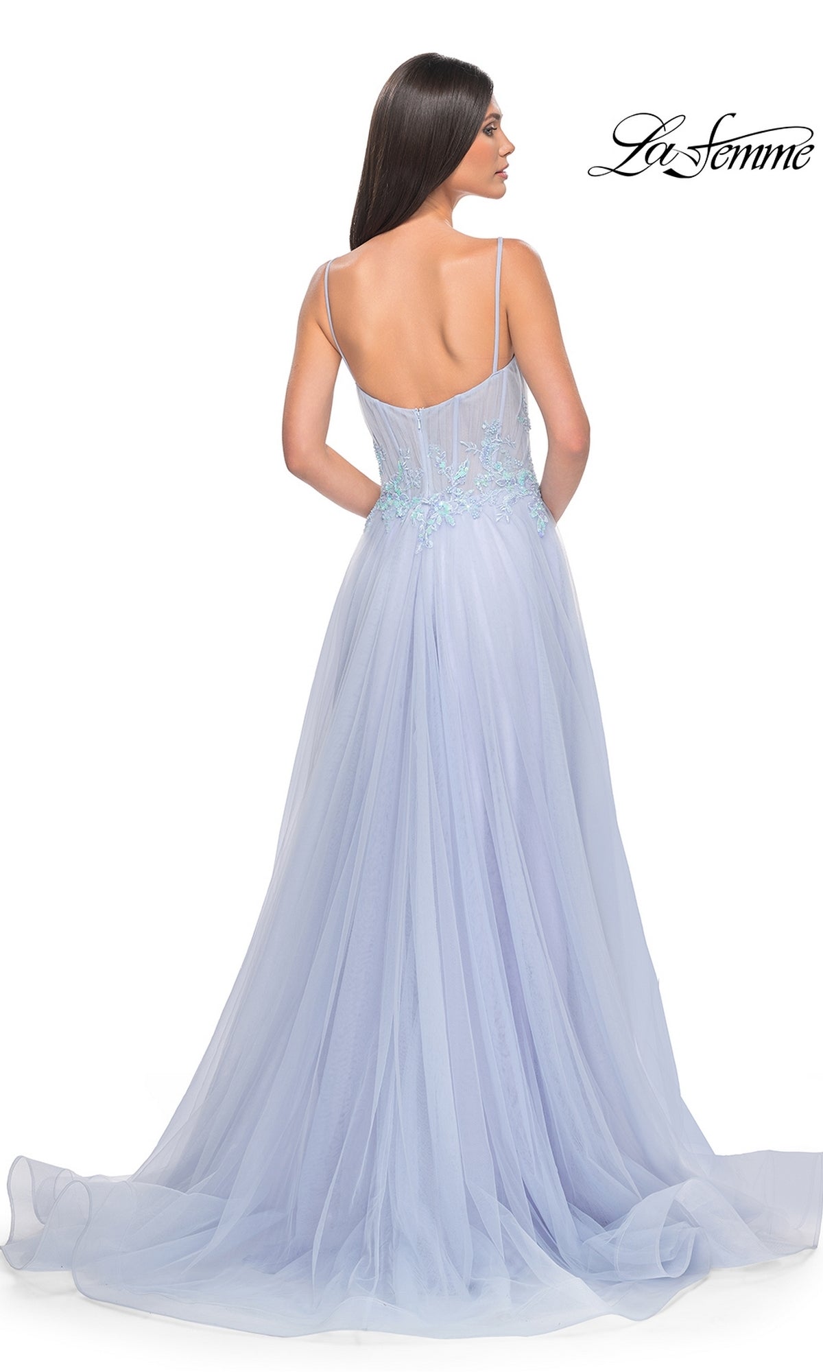 A woman models the La Femme A-Line Long Periwinkle Prom Dress 32293—an elegant, floor-length sleeveless gown with thin straps and embroidered details—shown from the back.