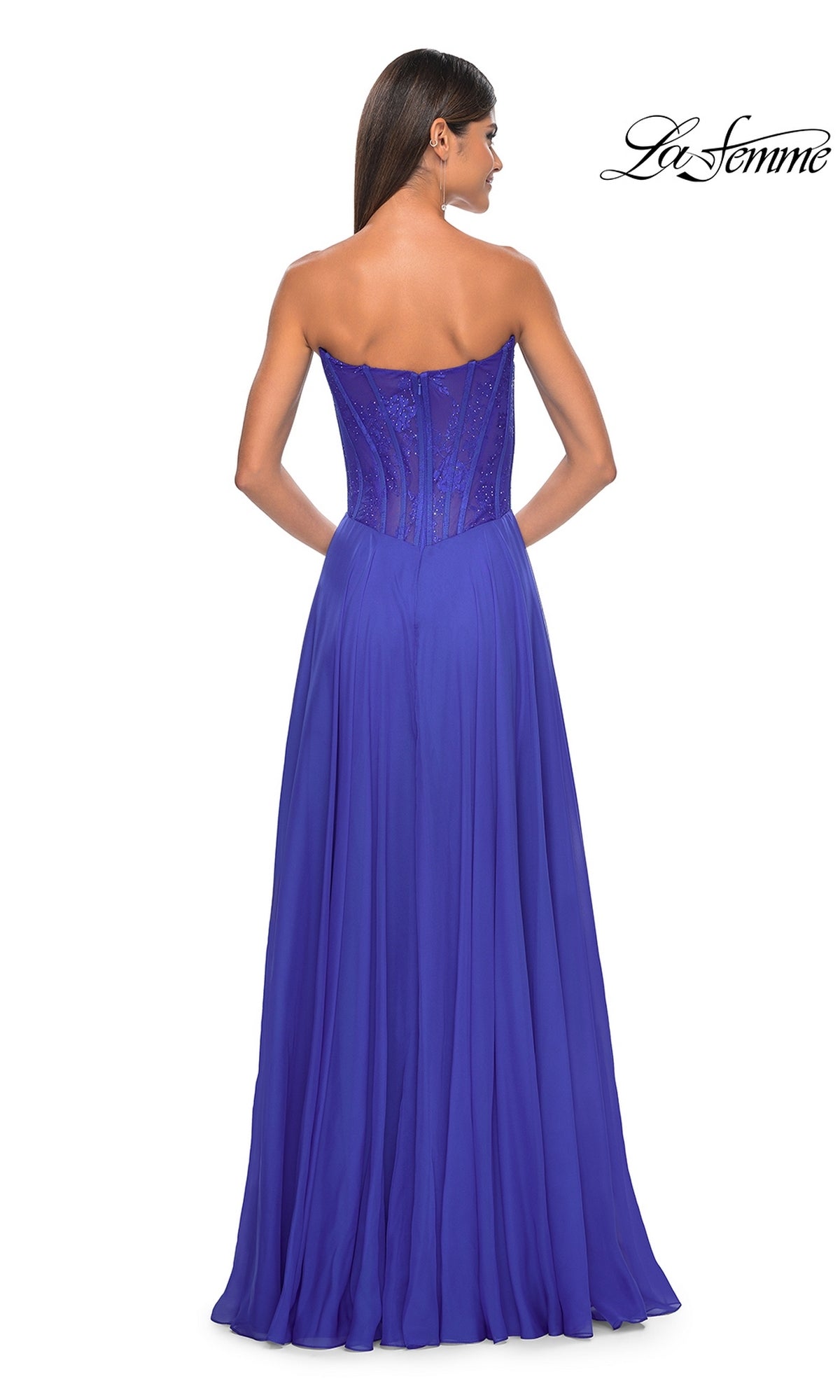 A woman is seen from the back in the La Femme Lace-Bodice Long A-Line Prom Dress 32311, featuring a strapless fitted bodice and a flowing royal blue floor-length skirt. The La Femme logo appears in the top right corner.