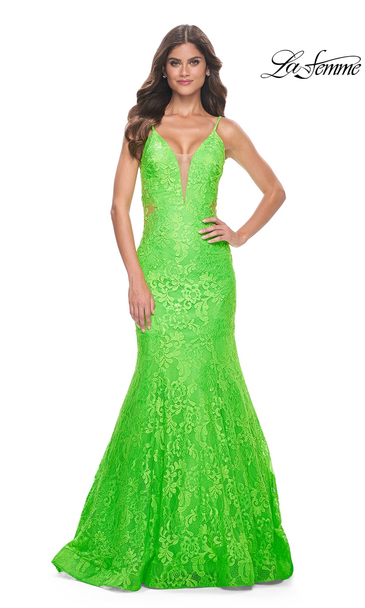 A woman wears the La Femme Bright Long Lace Mermaid Prom Dress 32314 in bright green, featuring a deep V neckline and thin straps, standing against a white background. La Femme logo appears in the top right corner.