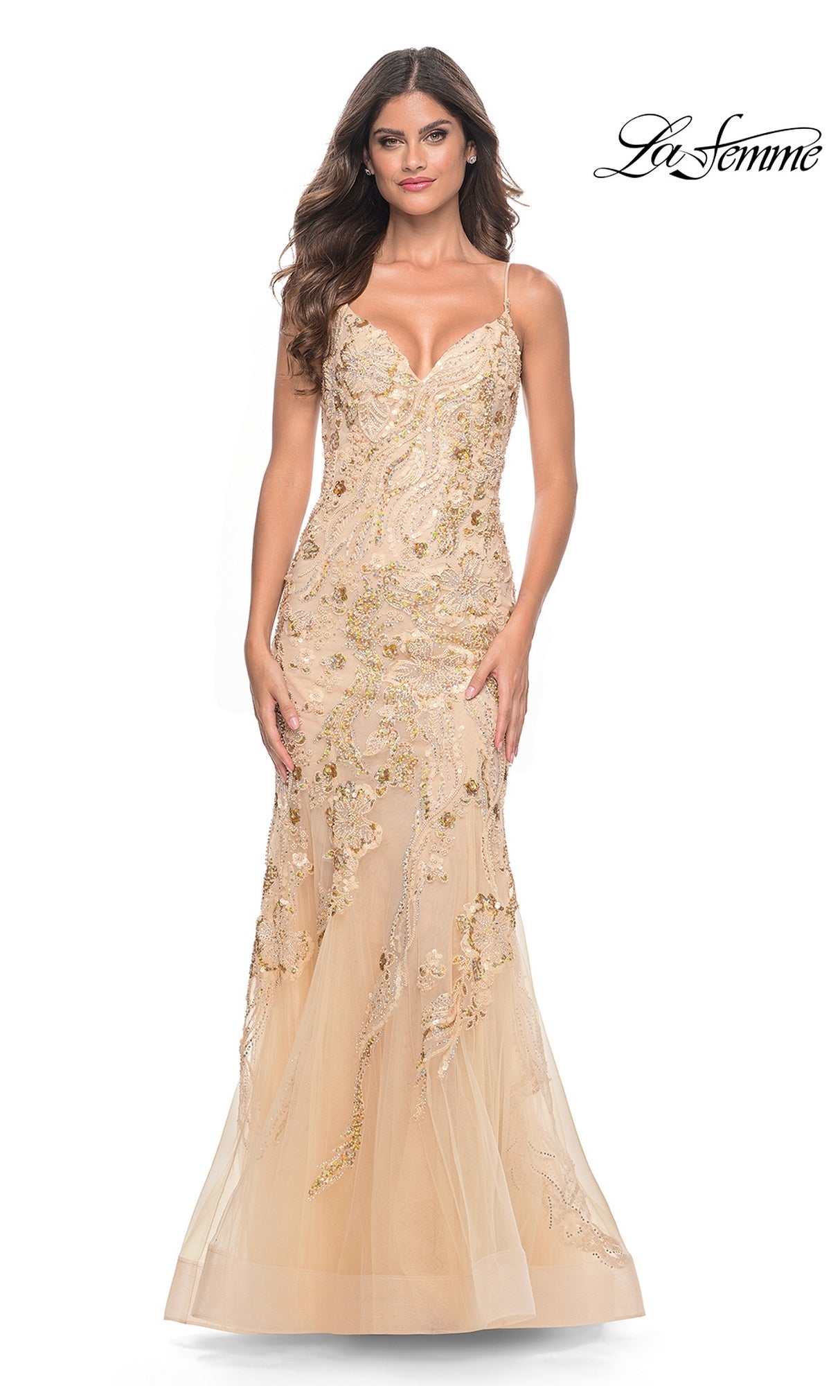 A woman wears the Le Femme Long Sequin-Lace Prom Dress 32333 in champagne, a fitted, floor-length mermaid gown with sequin lace embellishments, thin straps, and a sheer overlay. The La Femme logo is in the top right corner.