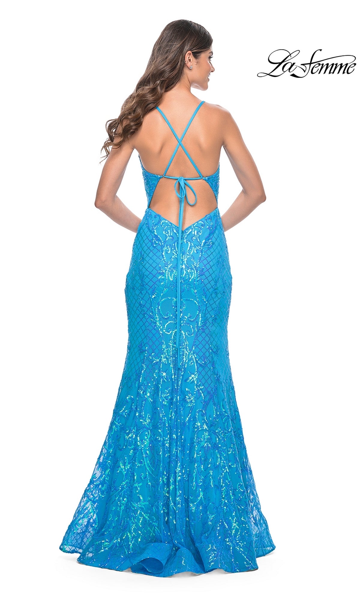 A woman models the La Femme Long Sequin Mermaid Prom Dress 32337, featuring a blue sequin print, open back, and crisscross straps, while standing and facing away; the La Femme logo appears in the top right corner.