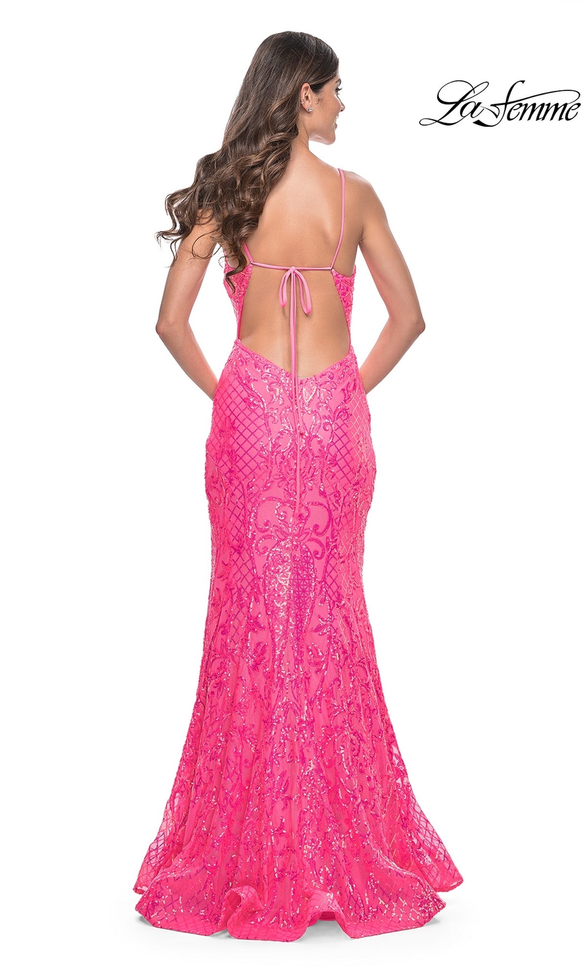 A woman with long brown hair models the La Femme Long Sequin Mermaid Prom Dress 32337—bright pink, backless, with thin straps and a mermaid silhouette. The La Femme logo appears in the top right corner.