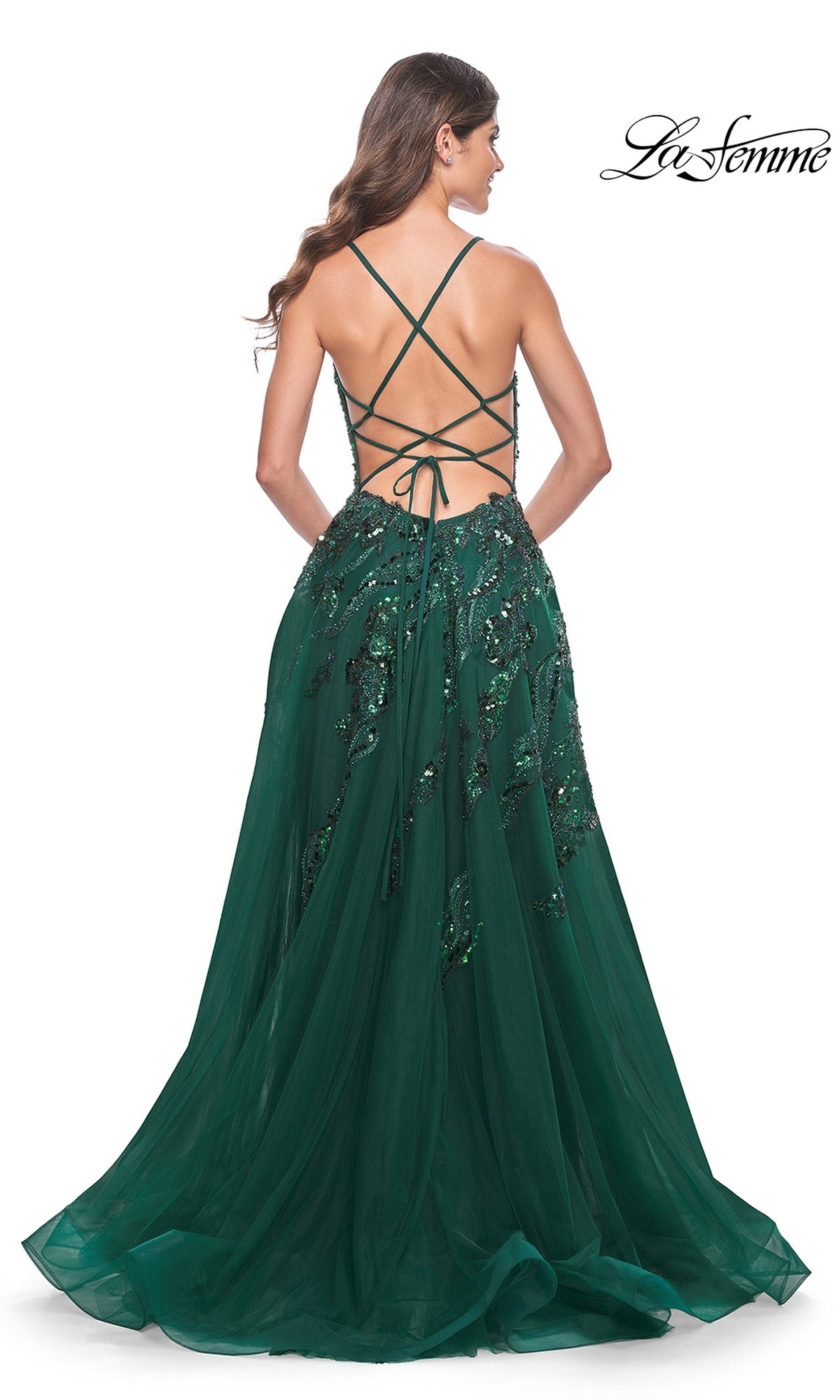 Woman in a La Femme Long A-Line Sequin-Print Prom Dress 32346, floor-length with crisscross lace-up open back and sequin floral print, standing with her back to the camera.