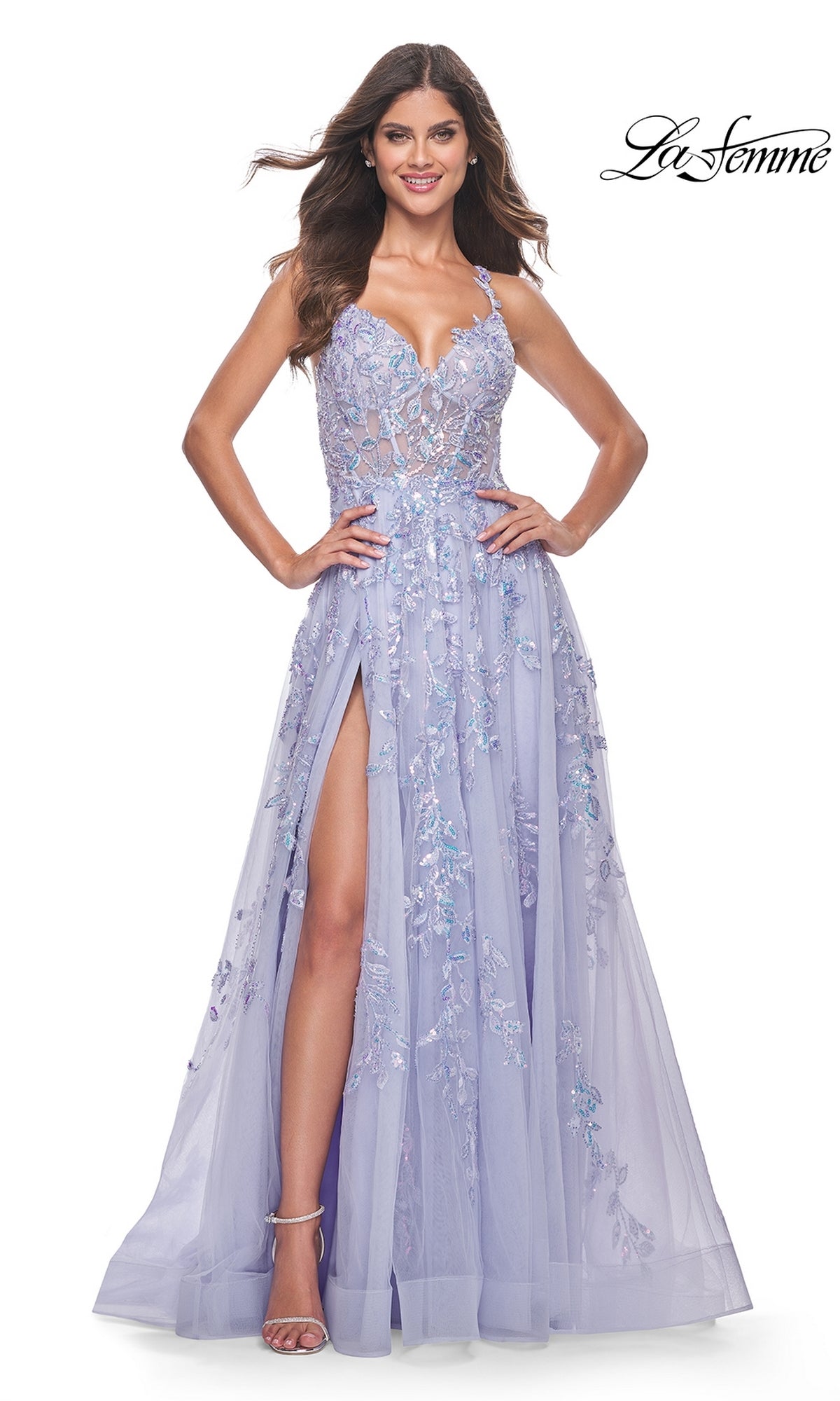 Smiling woman in the La Femme Long Periwinkle A-Line Prom Dress 32349, featuring sequin-lace embroidery, floral details, sheer bodice, spaghetti straps, high slit; “La Femme” logo appears in the top right corner.
