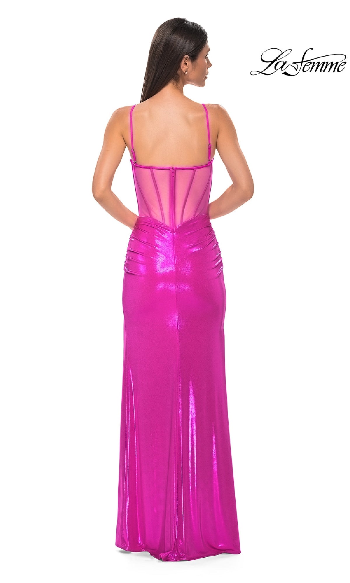 A woman is shown from the back wearing the Long Prom Dress: La Femme 32526 in shiny bright pink metallic fabric with a sheer-back, sleeveless ruched bodice, set against a plain white background. The La Femme logo appears in the top right corner.