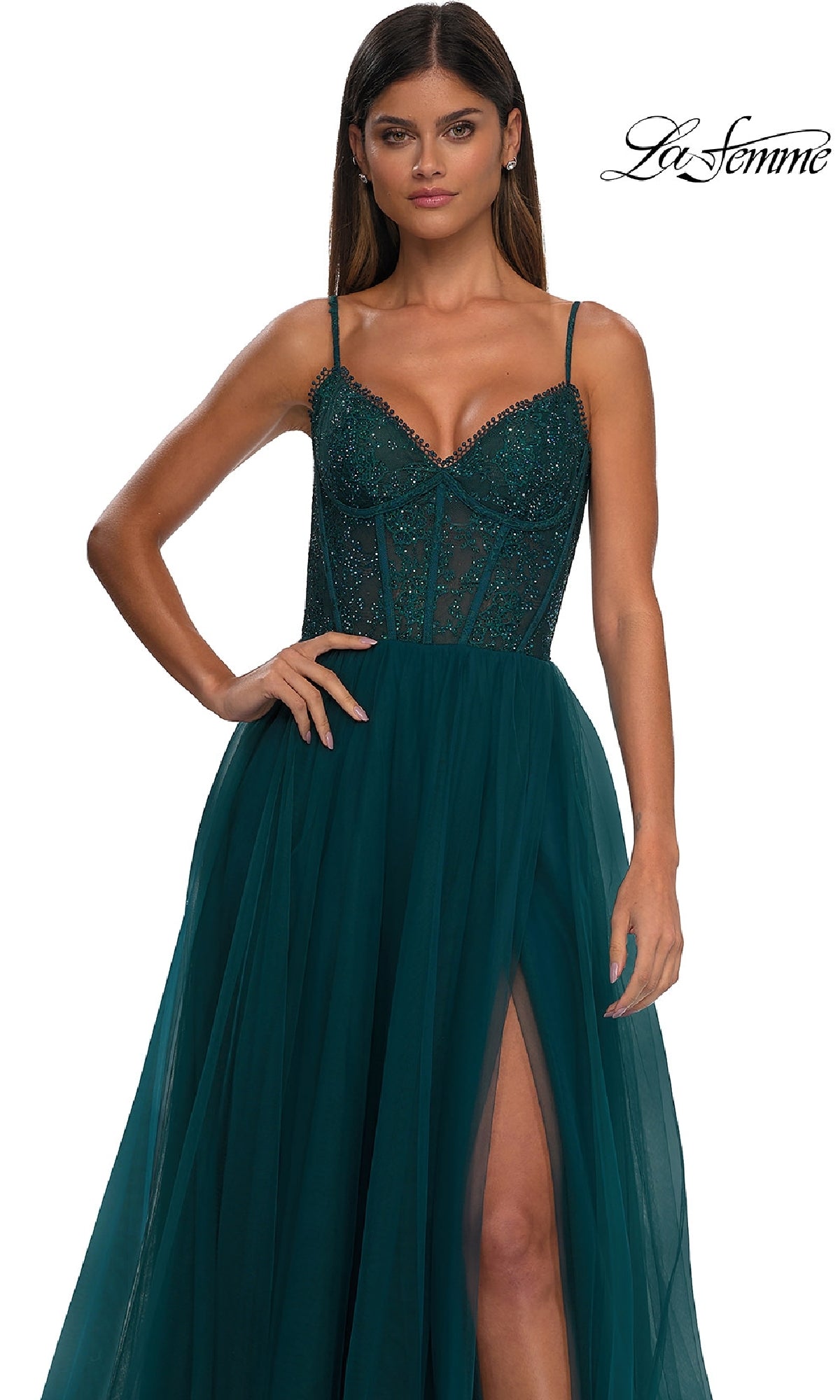 Woman wearing the Beaded-Bodice Long Prom Ball Gown: La Femme 32594 in dark teal, featuring strappy shoulders, a beaded bodice, sheer corset details, and a high-slit skirt. The La Femme logo is shown in the top right corner.