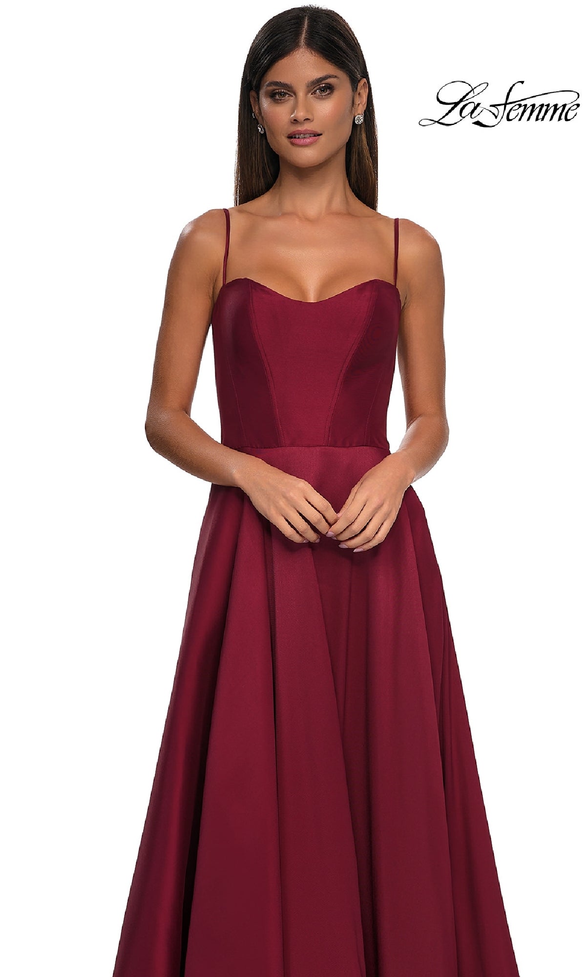 A woman models the Sheer-Corset Long A-Line Prom Gown (La Femme 32670), a sleeveless, floor-length burgundy Mikado dress with thin straps, against a white background. The